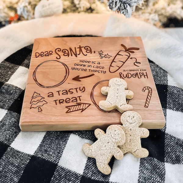 Engraved wooden Santa treat tray with cookie plate design, featuring "Dear Santa" text and holiday drawings including reindeer and candy cane motifs.