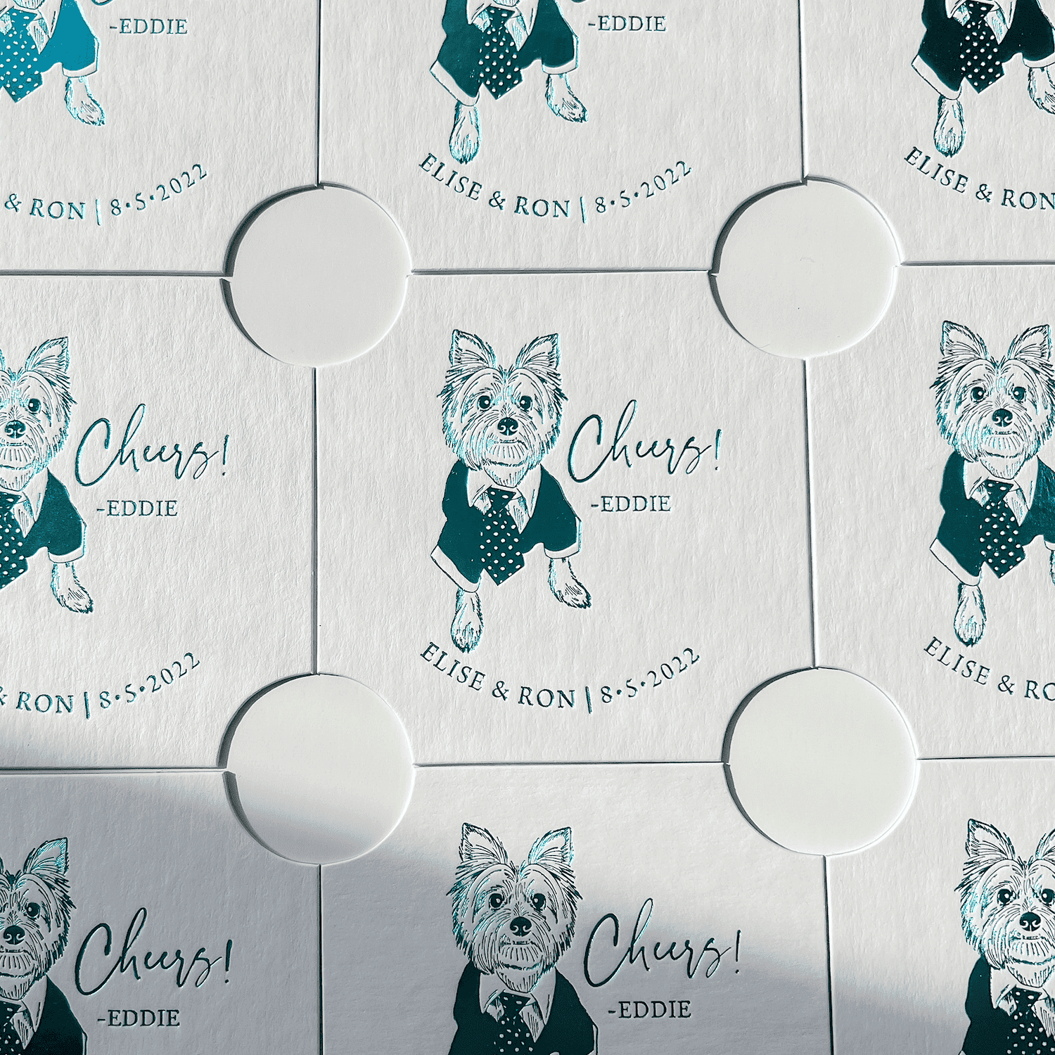 Personalized coasters with illustrated dog wearing bow tie and "Cheers" text with names and wedding date in teal and gray.