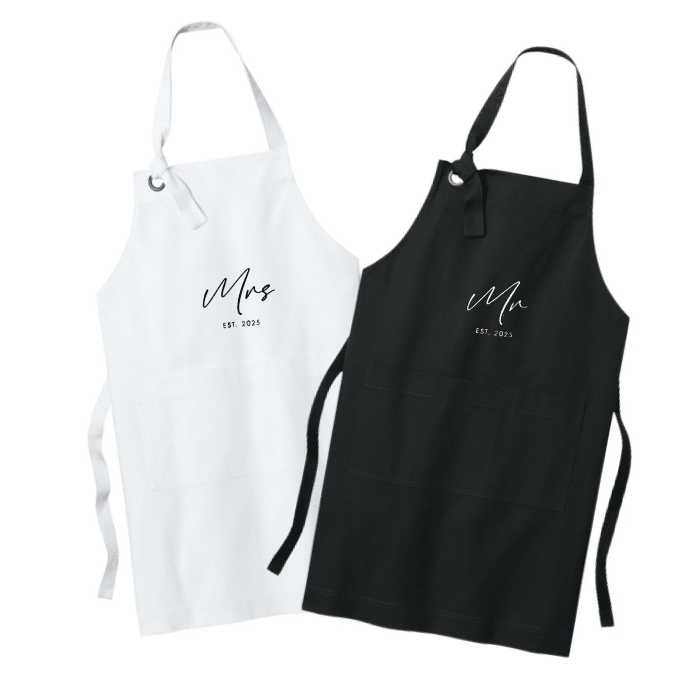 White and black aprons with "Mrs" and "Mr" embroidered text and wedding date, displayed as a pair with adjustable neck straps and waist ties.