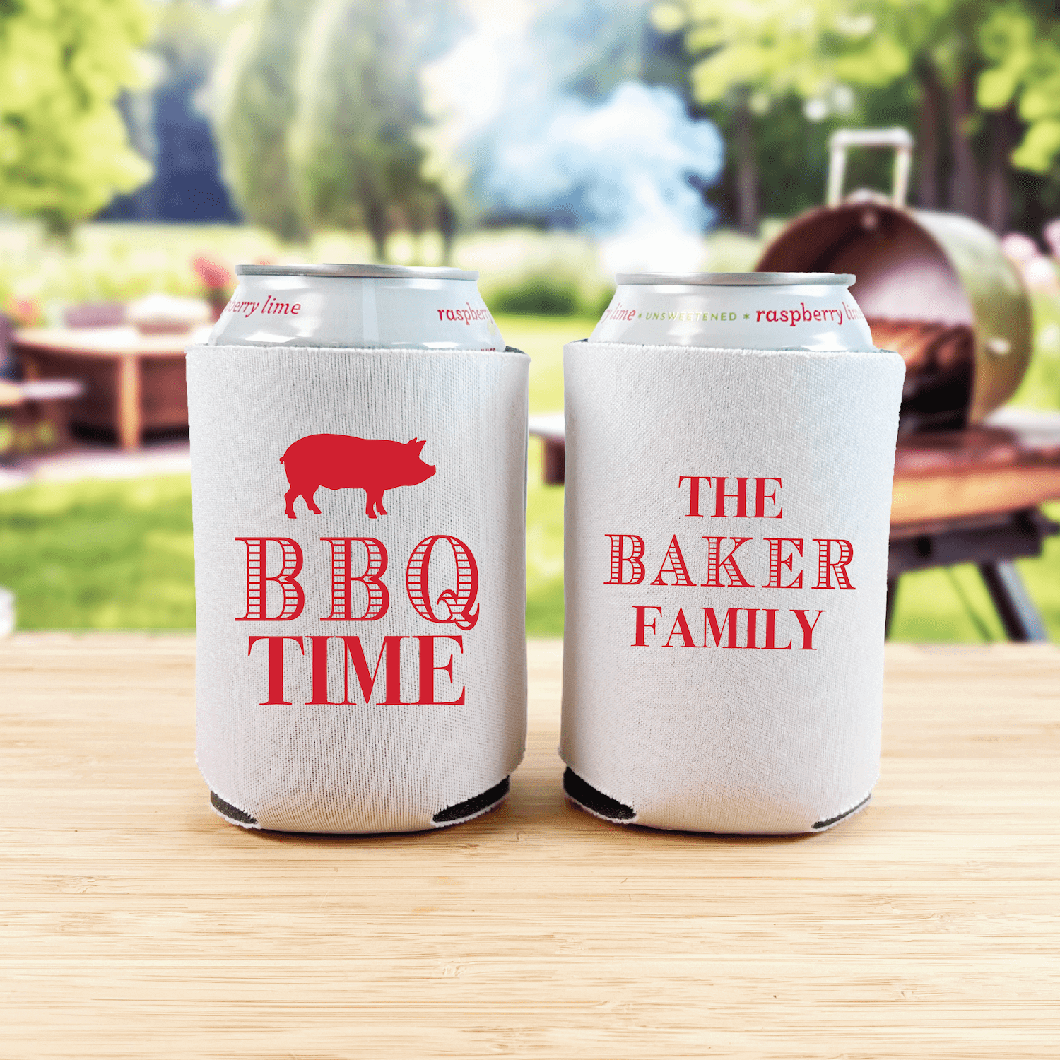 White can coolers with red text reading "BBQ TIME" with pig graphic and "THE BAKER FAMILY" displayed on wooden table outdoors.