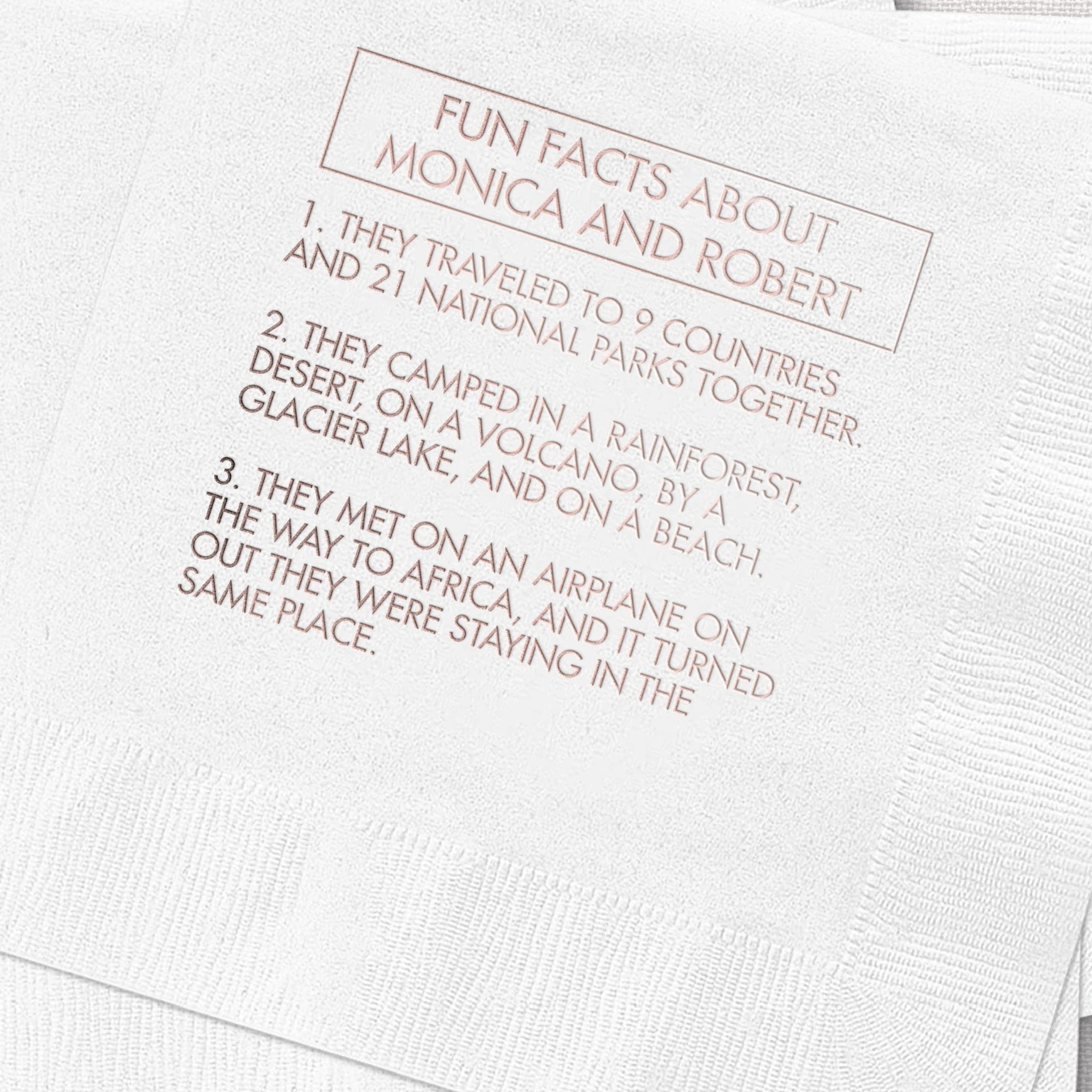 White cocktail napkin with rose gold foil-stamped text listing fun facts about Monica and Robert's relationship and travels