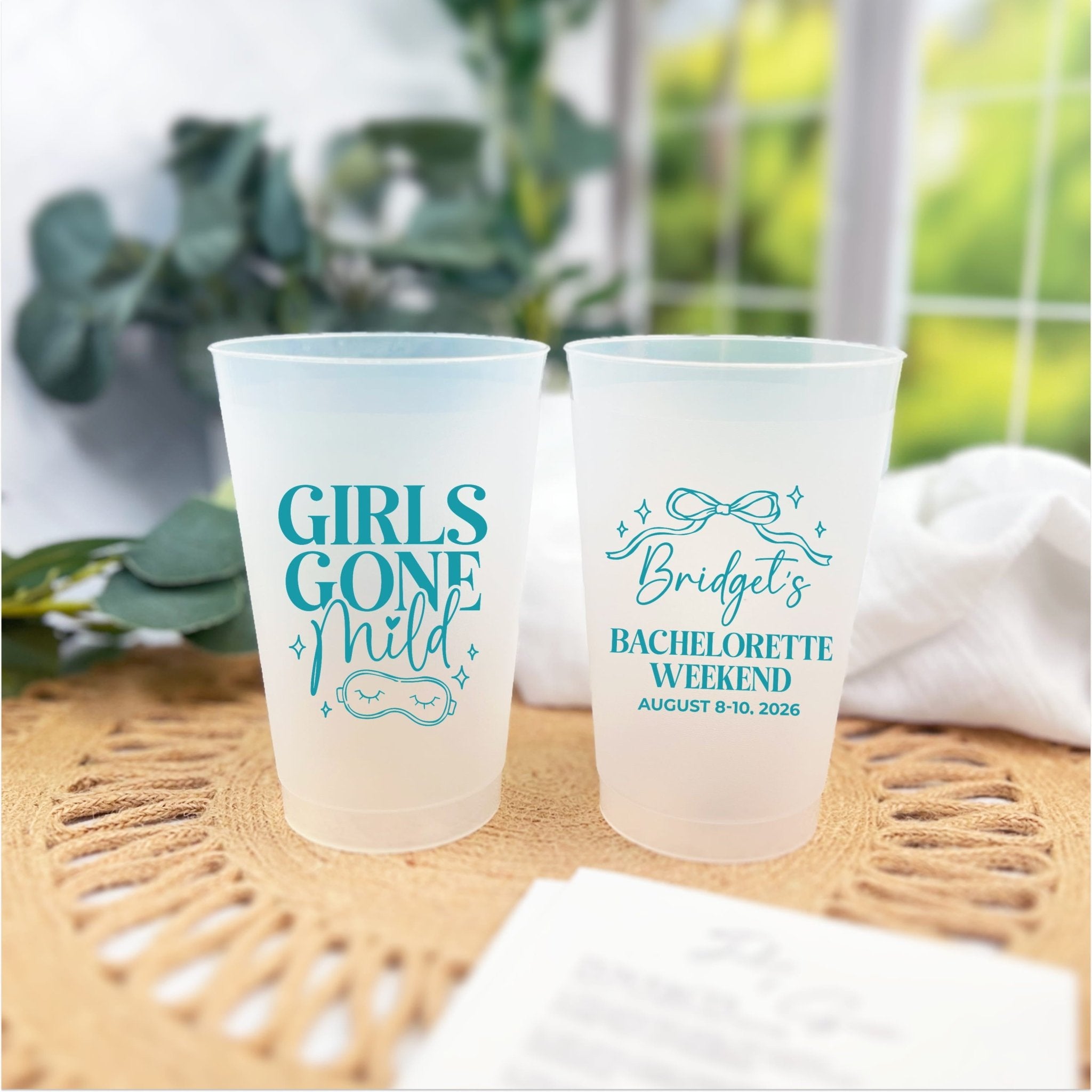 Girls Gone Mild personalized bachelorette cups in teal ink styled with a woven placemat and greenery