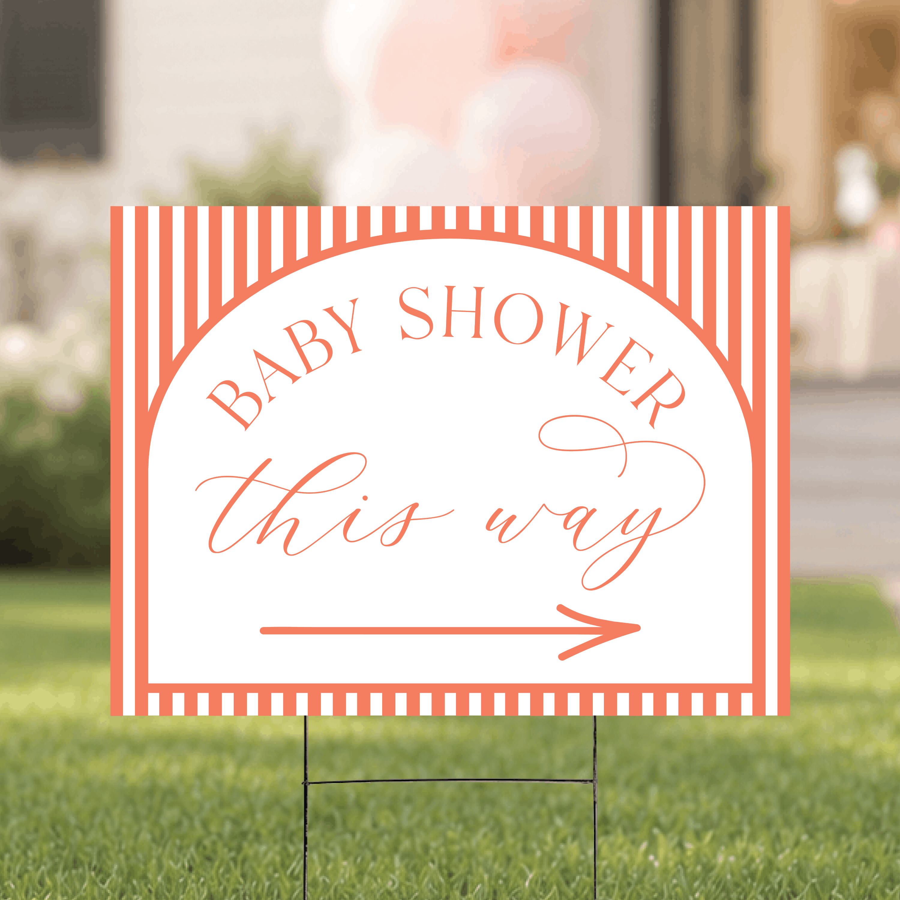 Colorful striped baby shower yard sign with directional arrow, displayed outdoors on a staked H-frame at a baby shower venue.