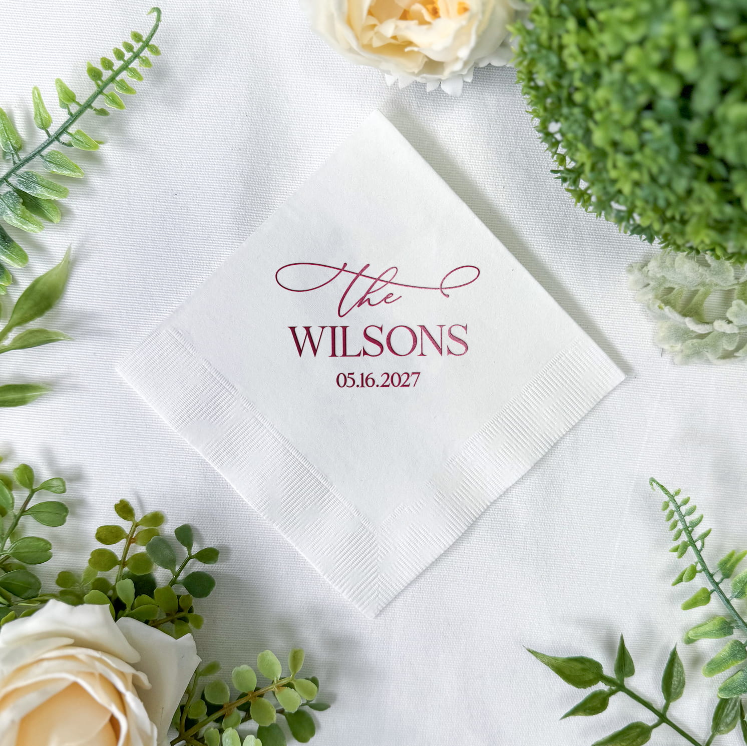 Real photo of a personalized cocktail napkin from The Elegant Last Name Complete Wedding Bar Suite, printed with an elegant last name design.