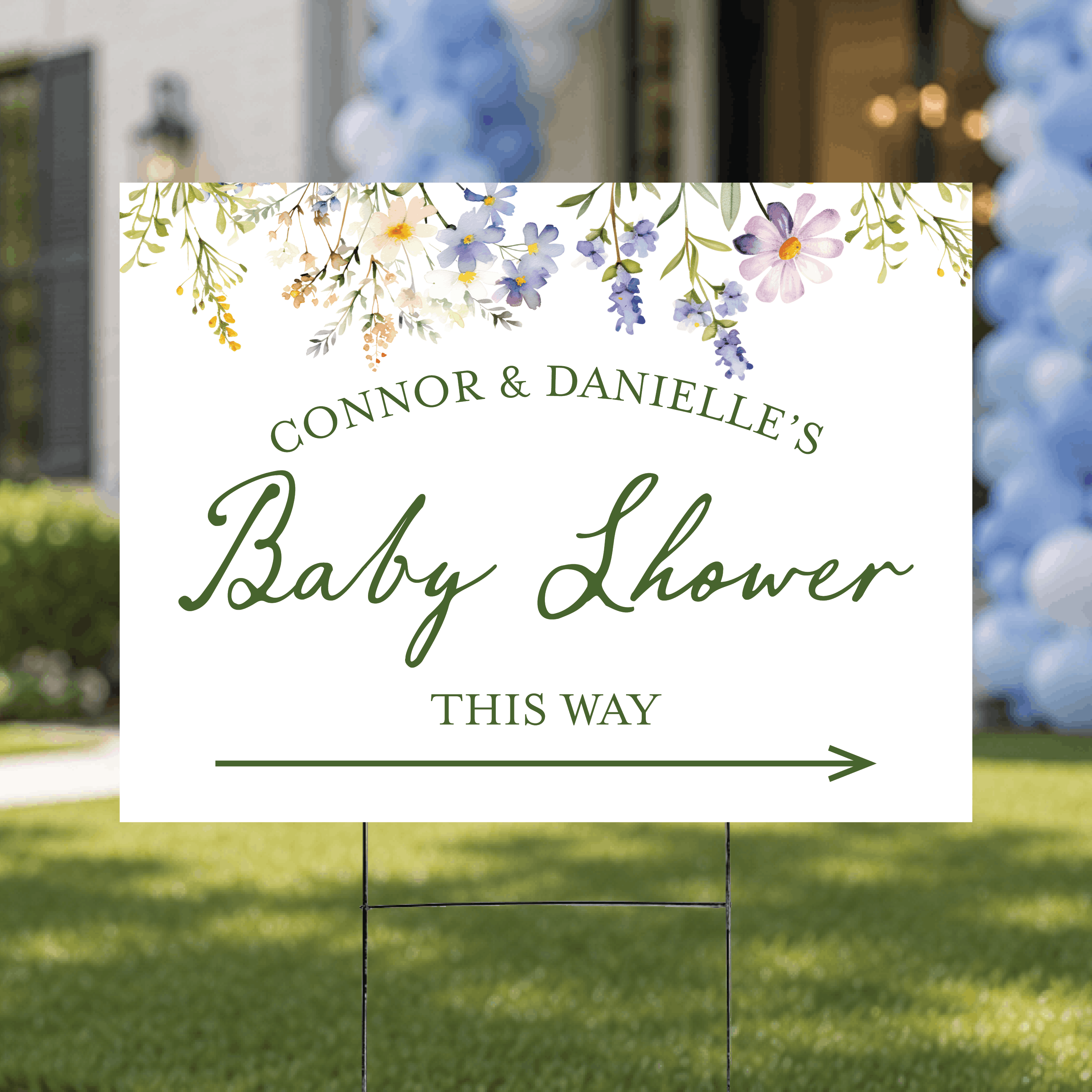 Styled flat lay of a personalized floral baby shower directional yard sign, highlighting the botanical floral pattern and custom ink color arrow design.