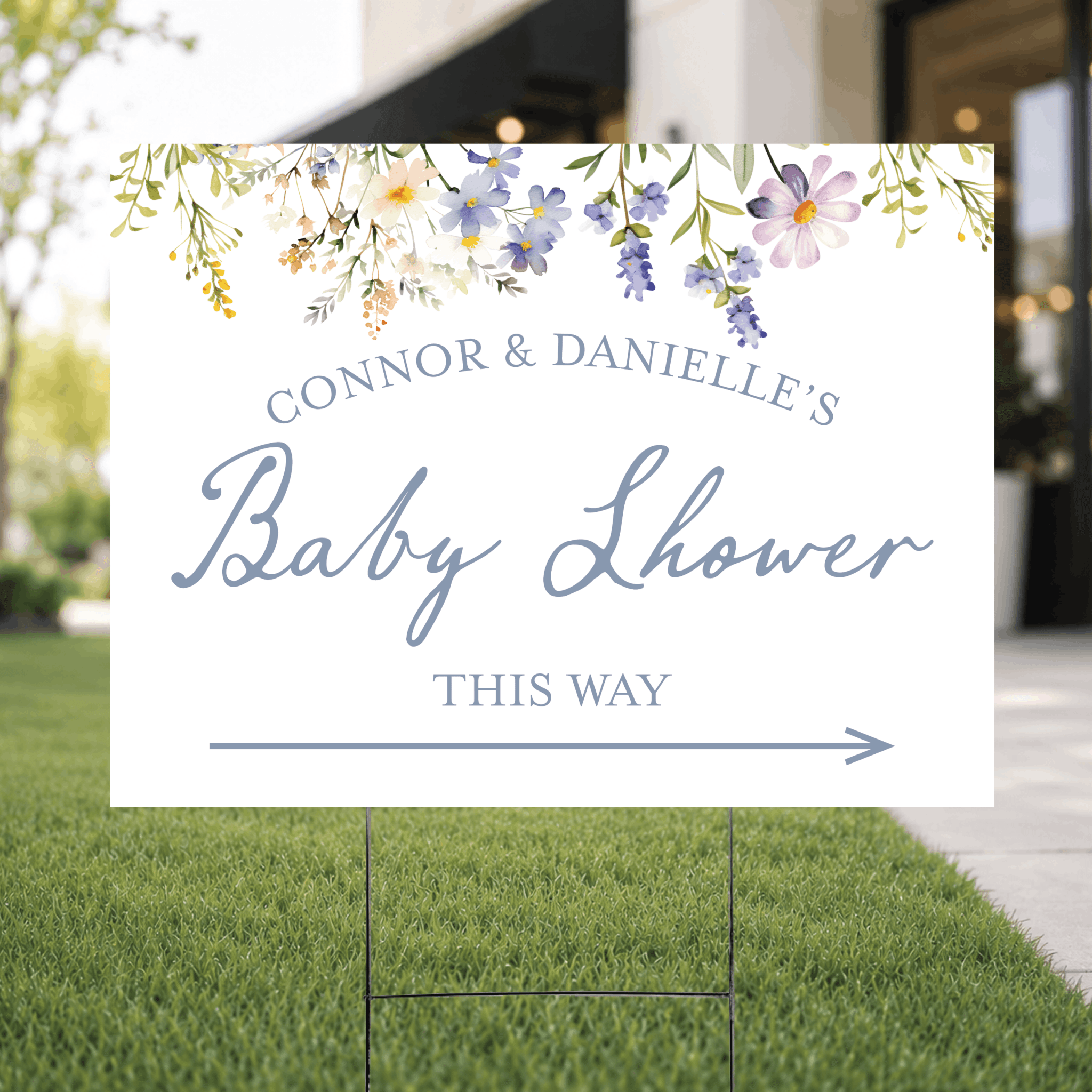 Close-up of a personalized floral baby shower yard sign showing the detailed botanical floral pattern with custom UV ink text and directional arrow.
