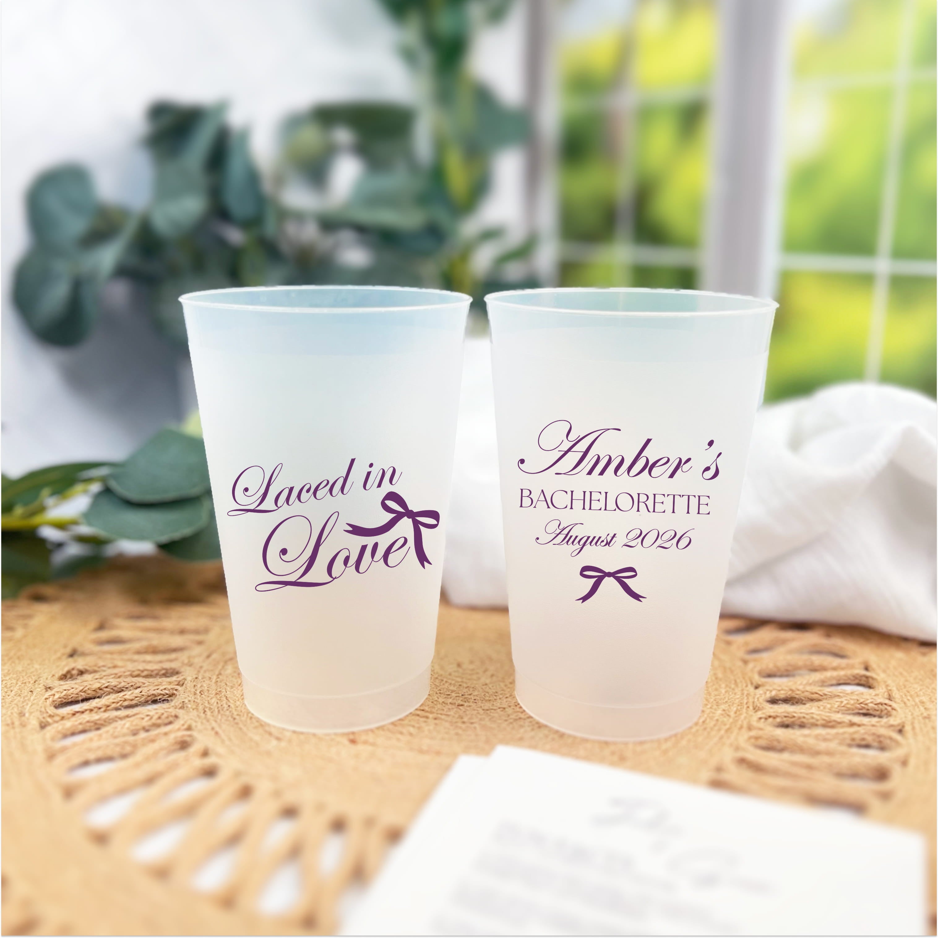 Laced in Love personalized bachelorette cups in plum ink styled with a woven placemat and greenery