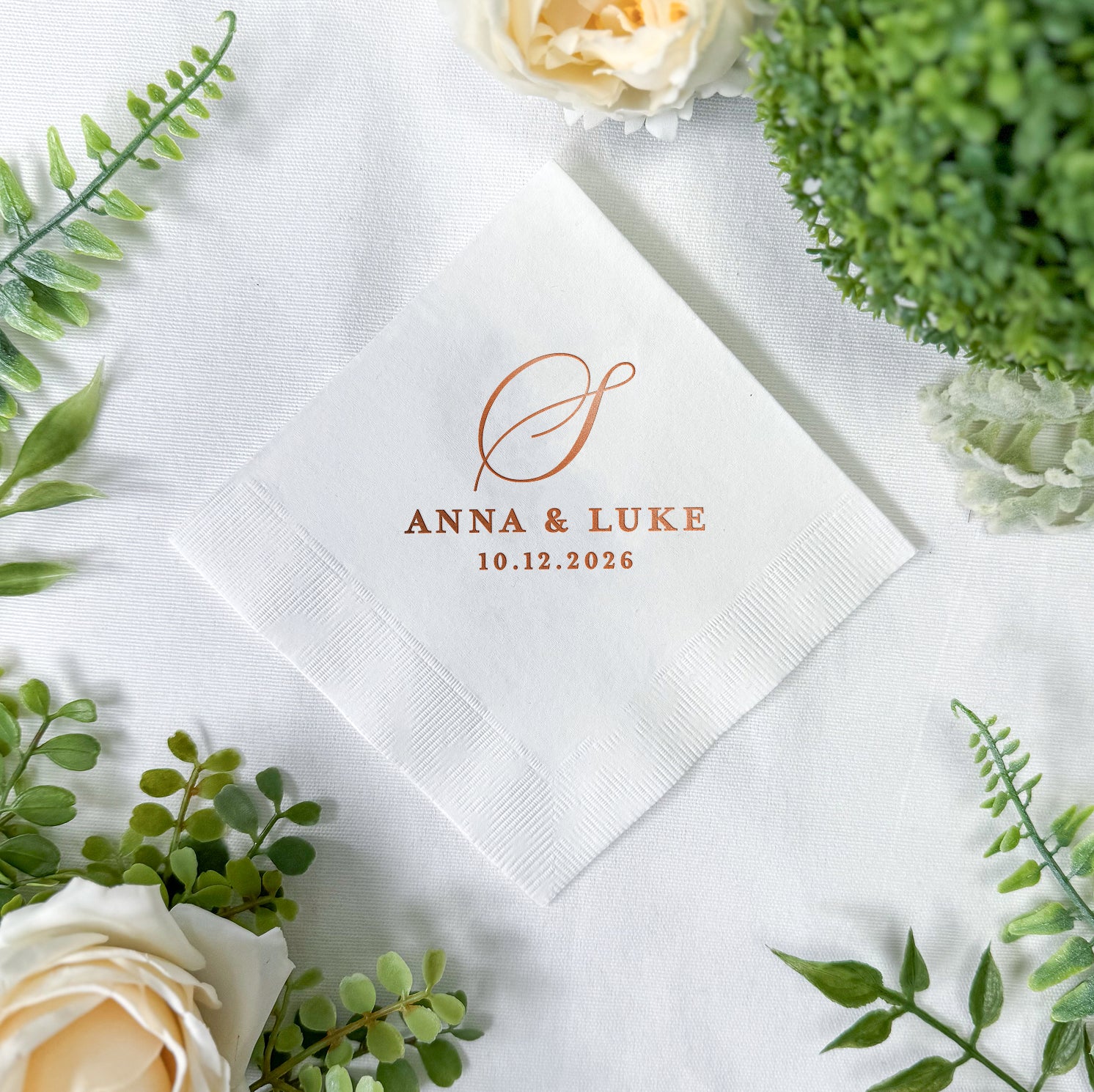 Personalized cocktail napkins with classic single initial monogram design showing couple's names and wedding date