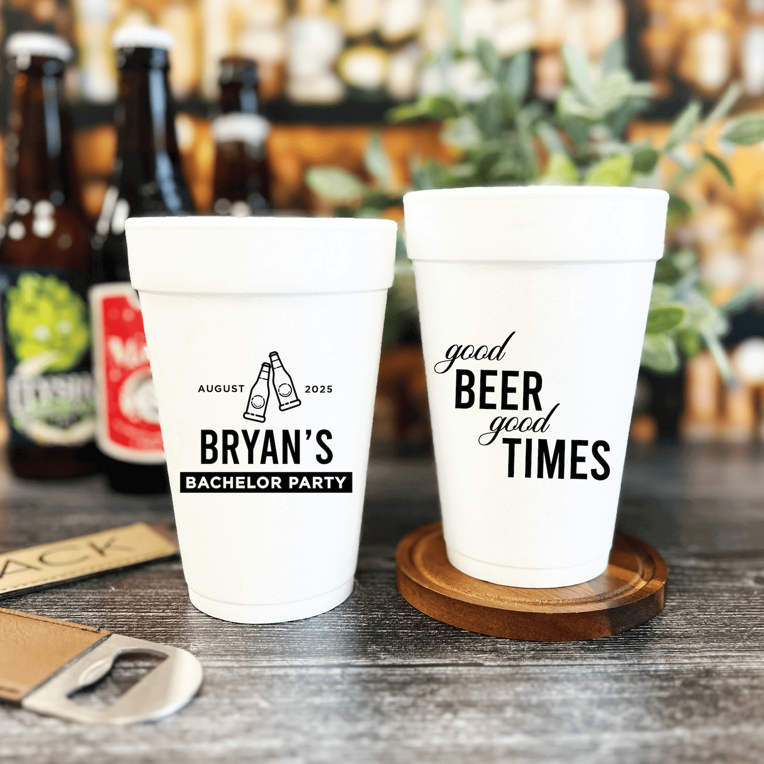 White foam cups with black text designs: left cup reads "Bryan's Bachelor Party" with beer bottle icon and date, right cup says "good BEER good TIMES"