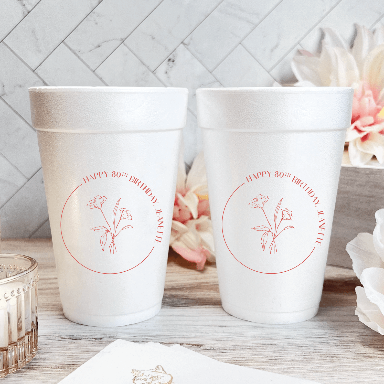 Two white foam cups with pink floral design and "Happy 80th Birthday" text in circular layout
