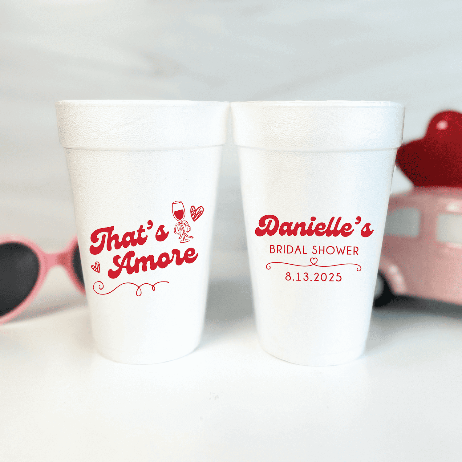 Pair of white foam cups with red text reading "That's Amore" and "Danielle's Bridal Shower 8.13.2025" personalized design