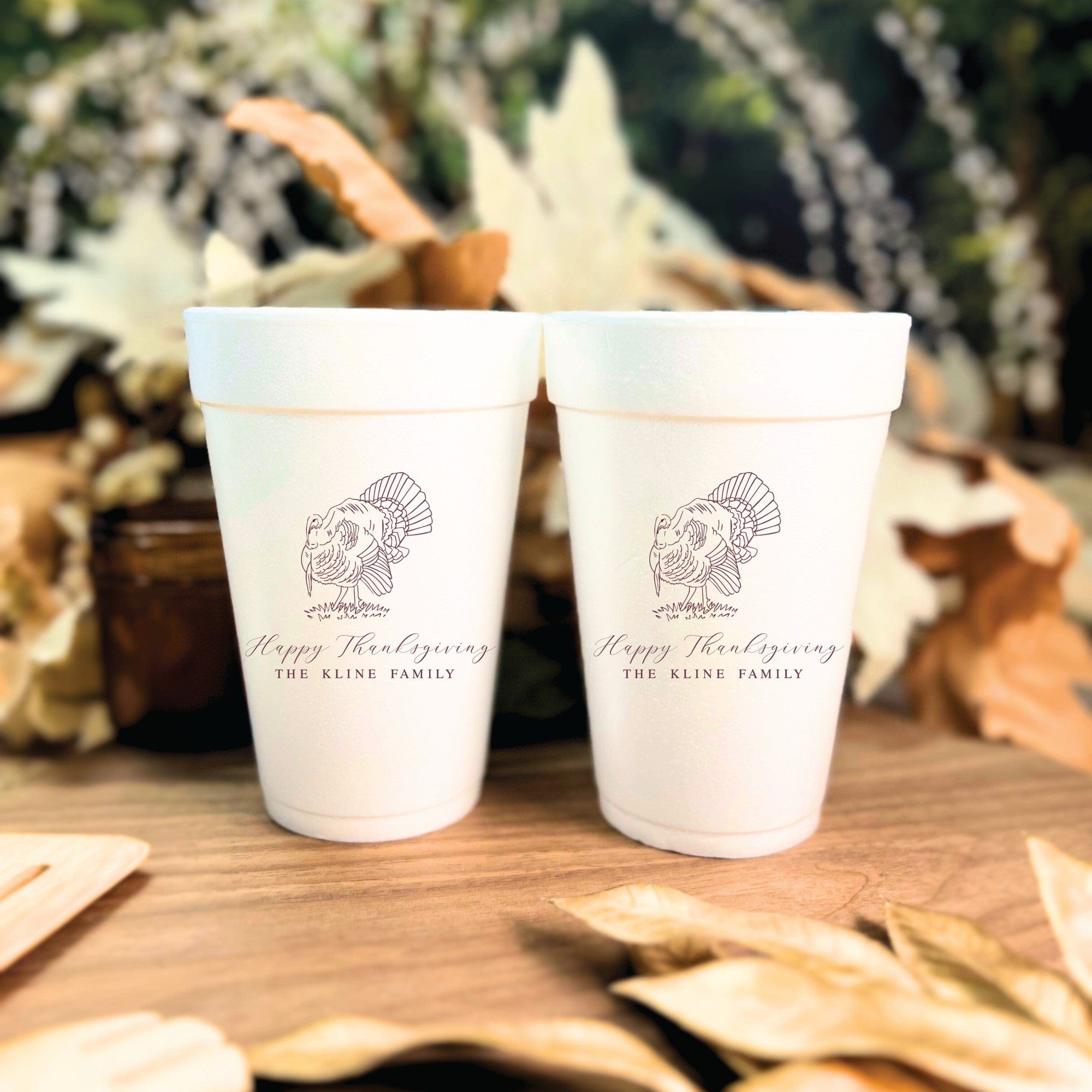 Two white foam cups featuring a custom turkey design for a Thanksgiving celebration.