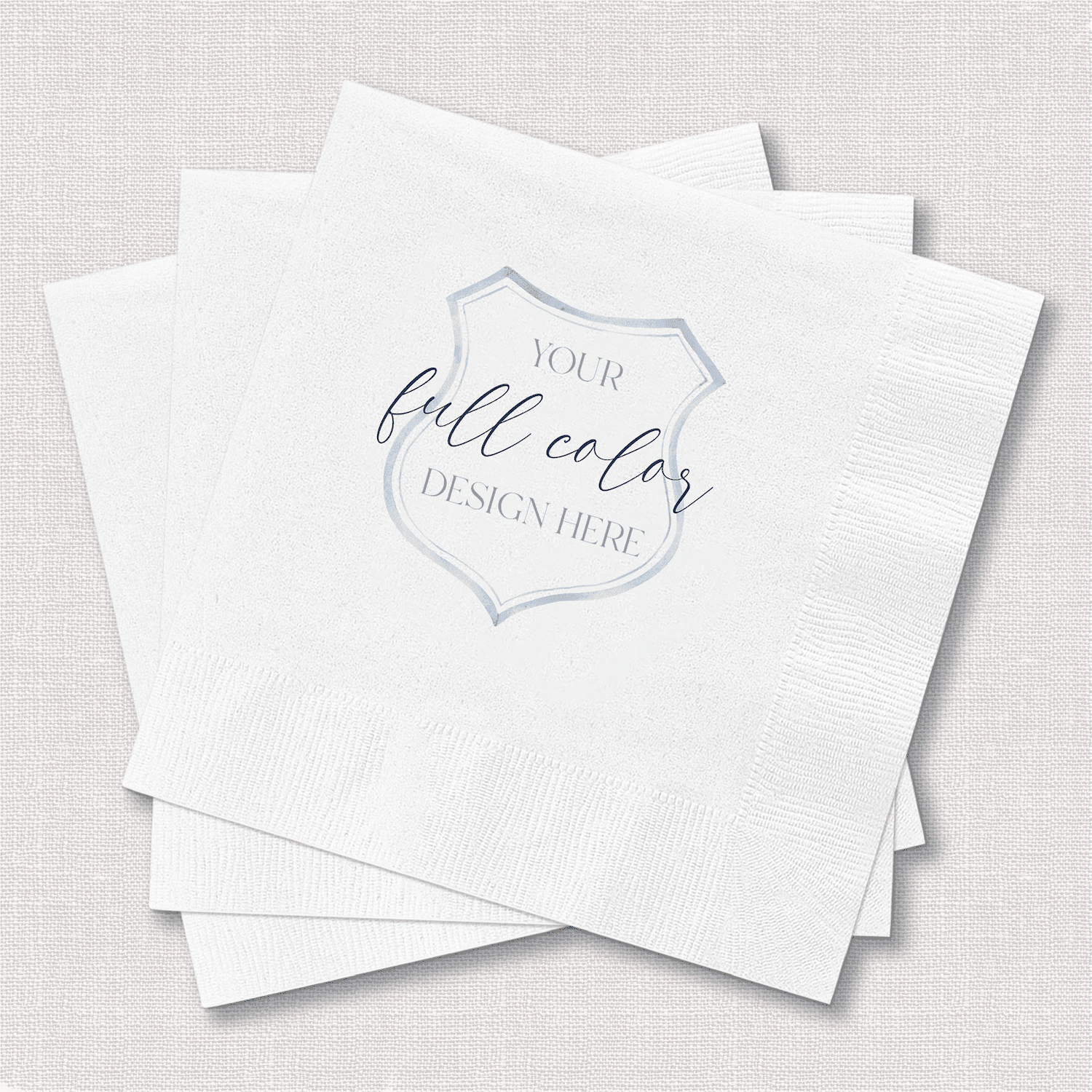 Stack of white beverage napkins with gray badge design and "Your full color design here" text placeholder