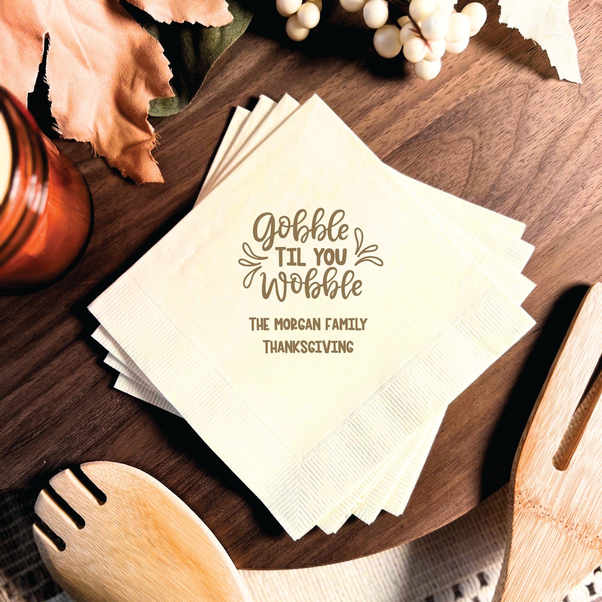 A stack of cream-colored, textured paper napkins, perfect for a personalized fall or Thanksgiving event.