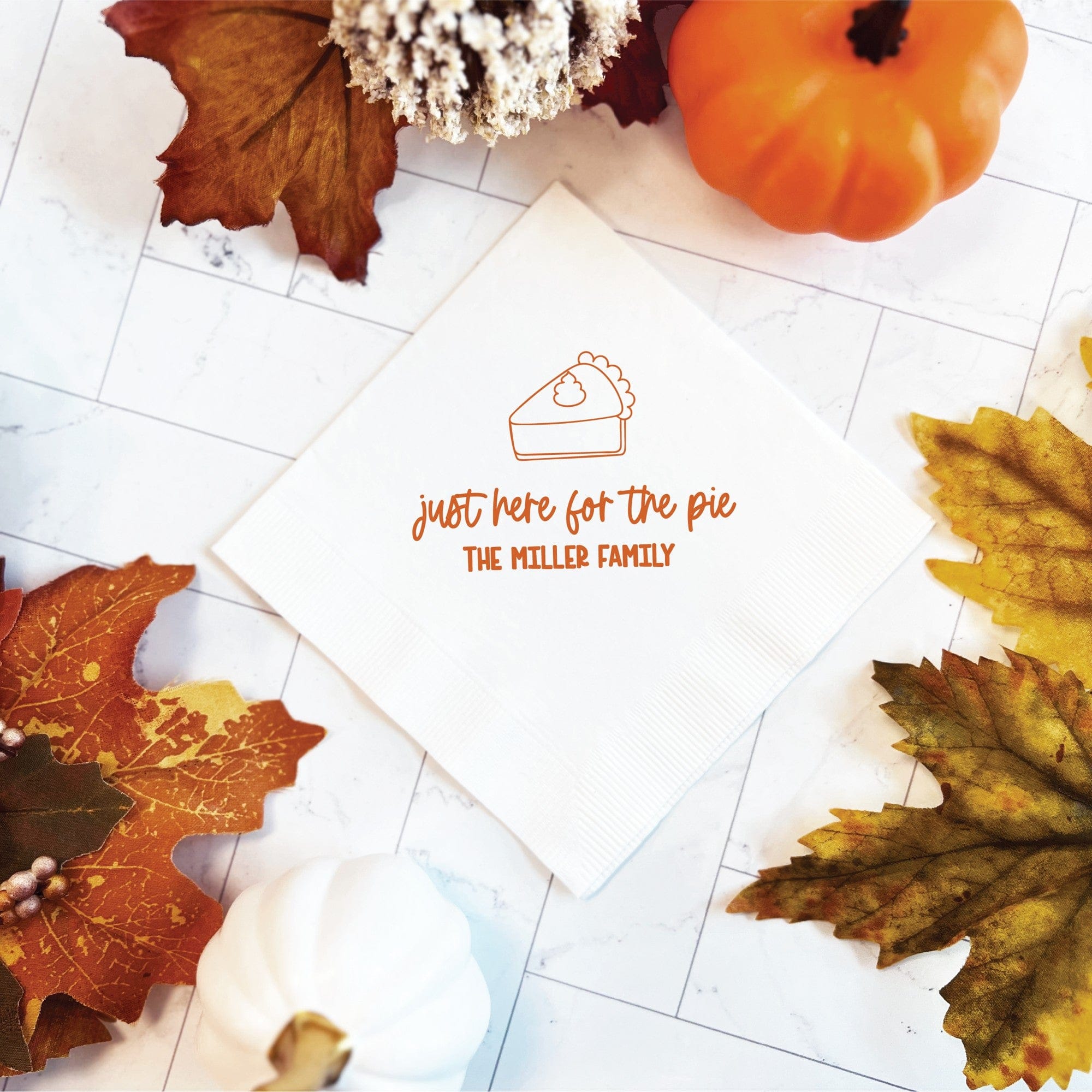 A white personalized paper napkin featuring a whimsical outline graphic of a pie slice with whipped cream, suitable for a Thanksgiving or fall celebration.