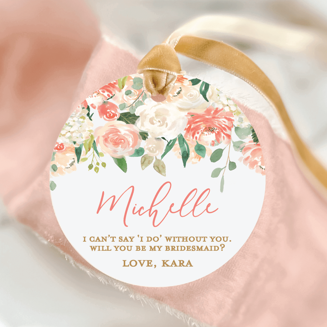 Round acrylic ornament with coral floral design, personalized name "Michelle" in script, bridesmaid proposal message, and gold ribbon loop.