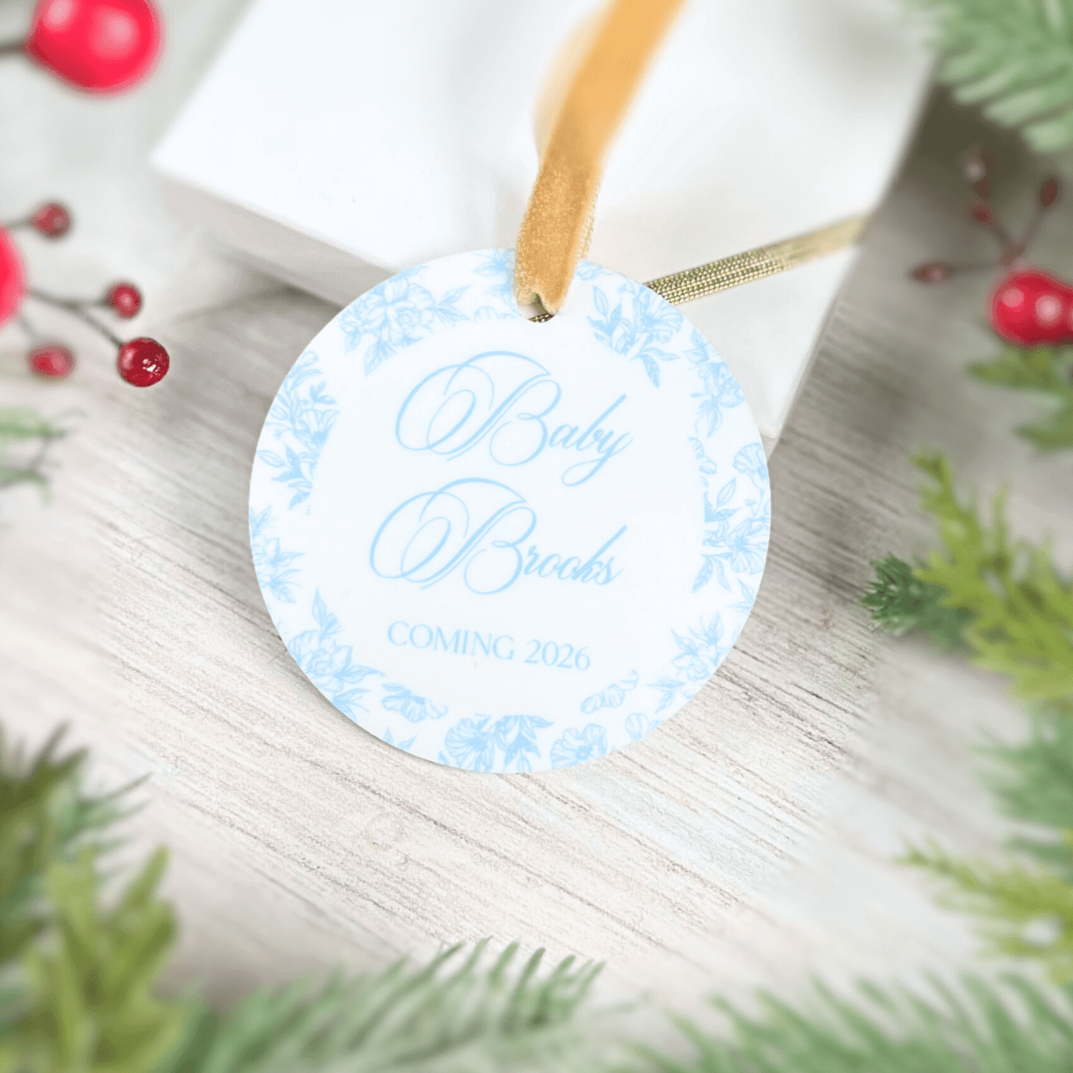 Blue toile baby announcement ornament with gold ribbon, personalized with "Baby Breeds Coming 2026" text.