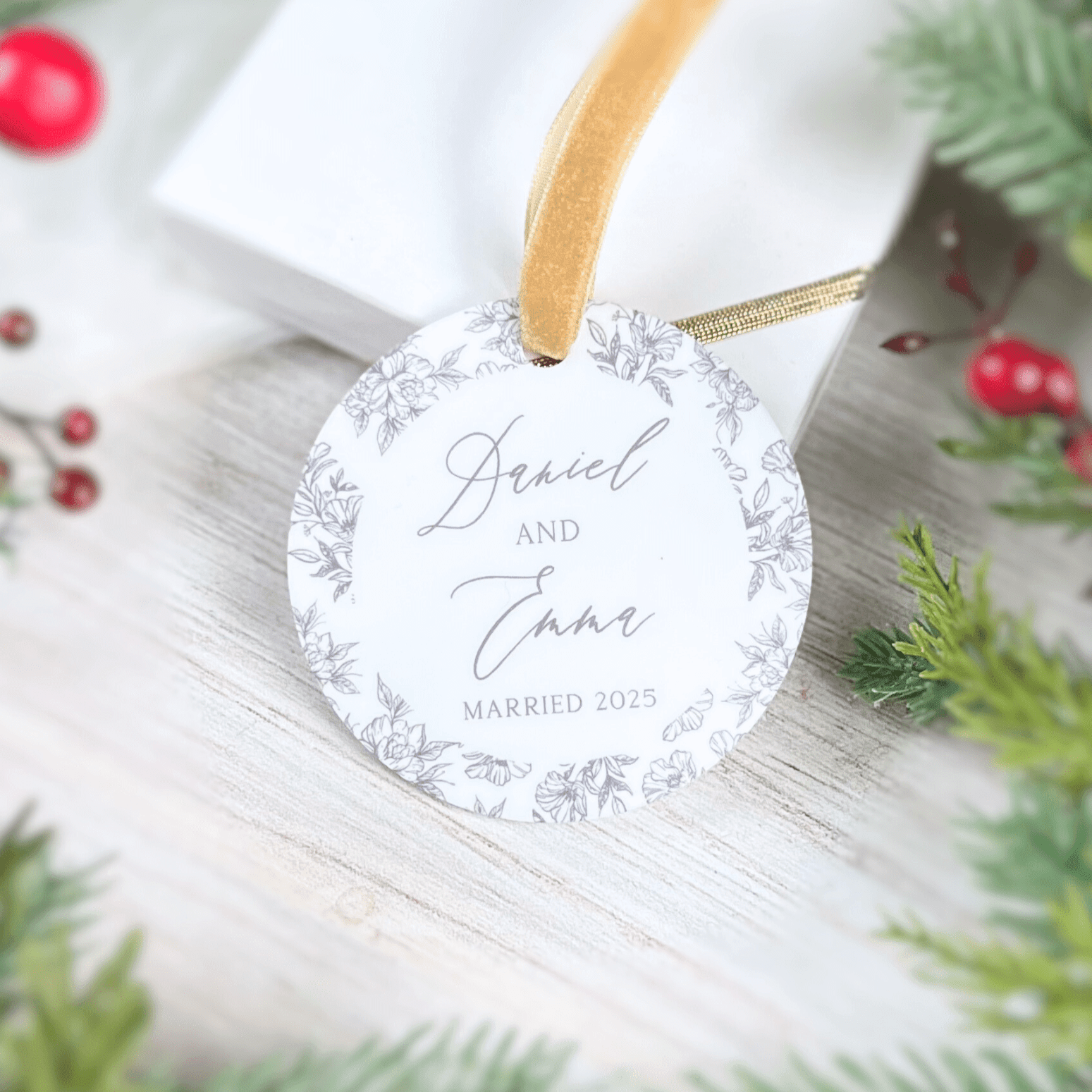 Round acrylic ornament with tan ribbon, featuring delicate toile design border and personalized text reading "Jewel and Char MARRIED 2025"