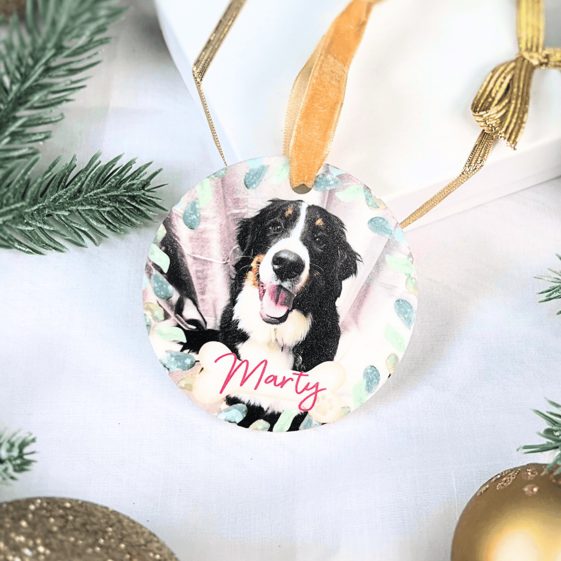 Personalized acrylic ornament featuring a black and white dog photo with the name "Marty" in red script, surrounded by watercolor floral details and greenery accents.