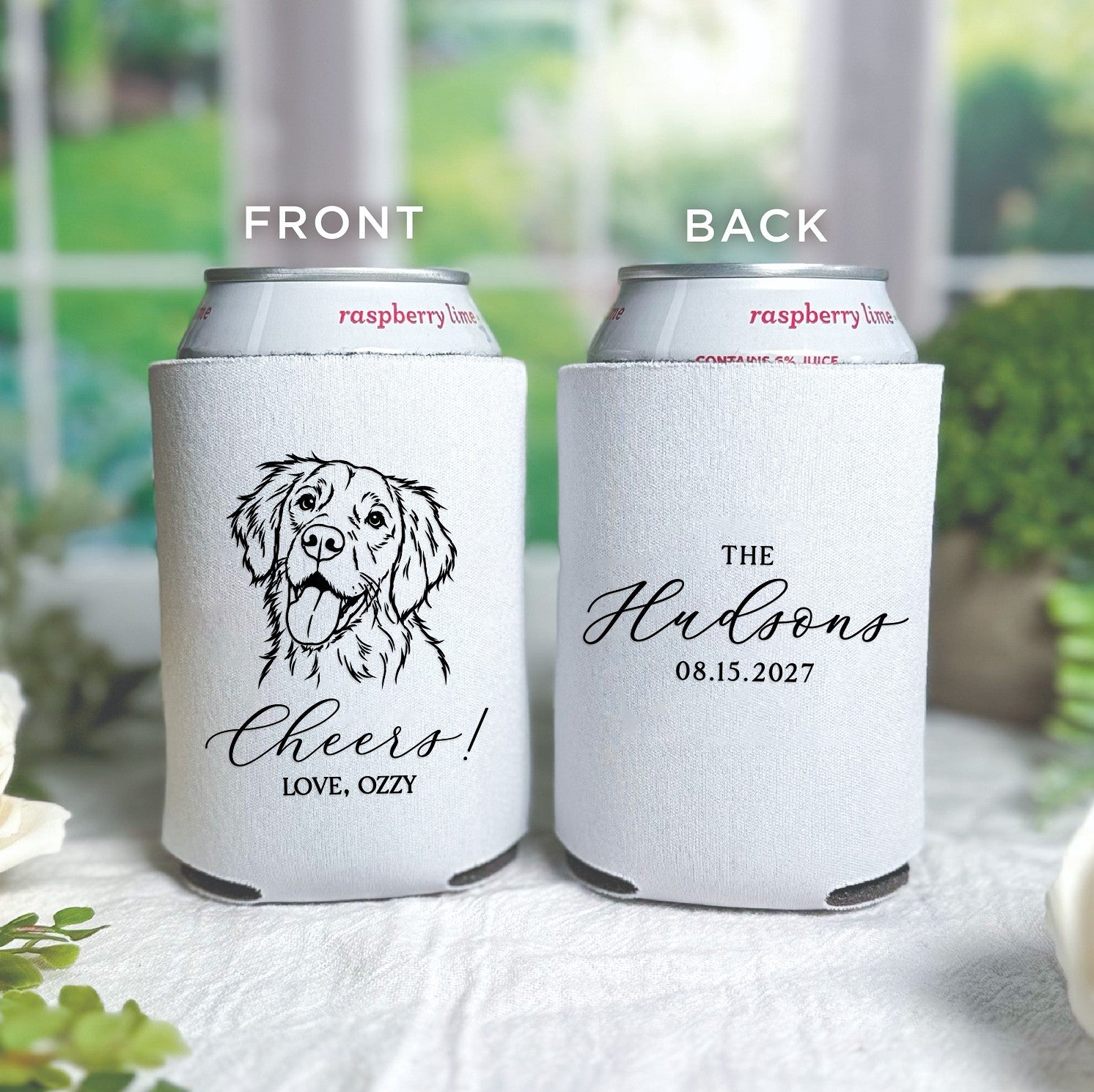 A personalized white fabric can cooler, featuring a custom black line-art dog illustration on the front and custom text on the back, serves as a charming wedding or event favor.