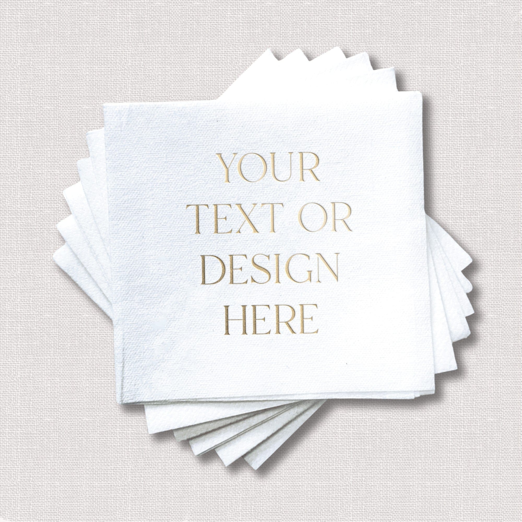 A stack of elegant white textured paper napkins with customizable gold foil text, ideal for a wedding or sophisticated event.