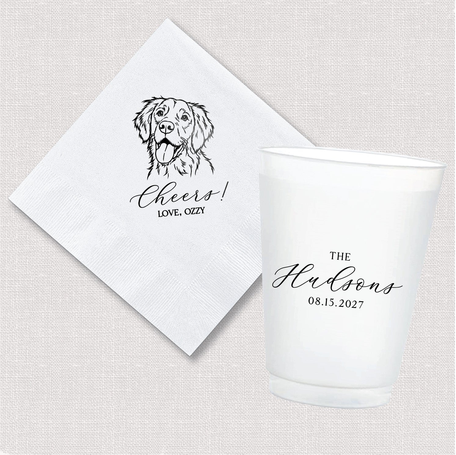A personalized white paper napkin featuring a dog illustration and a matching frosted plastic shatterproof cup with custom text, ideal for a wedding or celebratory event.