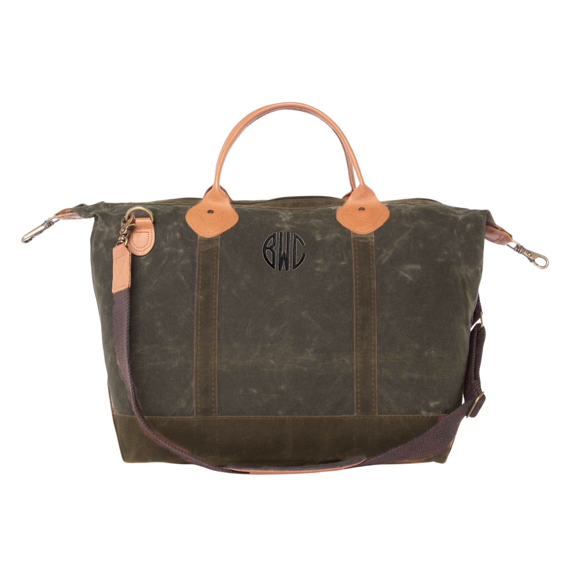 A personalized dark green waxed canvas weekender bag features sturdy tan leather handles, coordinating leather accents, and a dark brown detachable shoulder strap, ideal for travel or as a bridal gift.