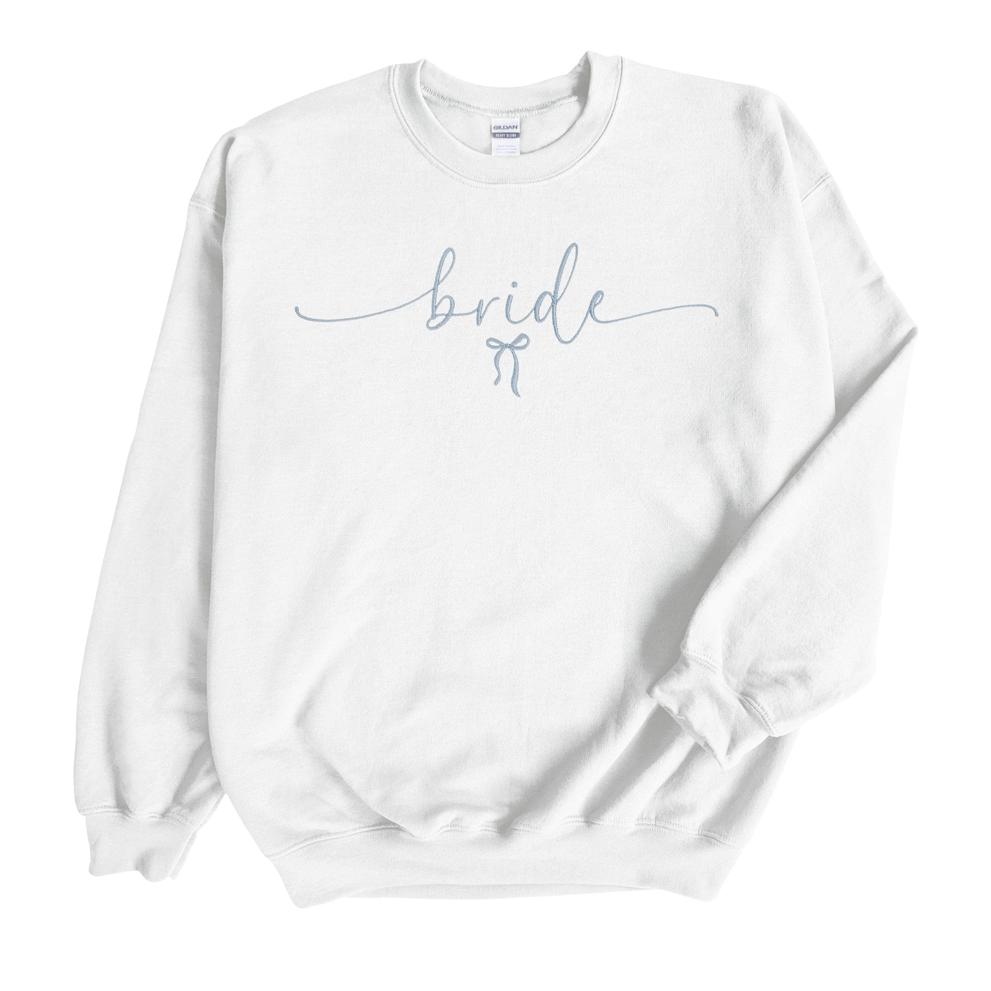 A cozy white crewneck sweatshirt features elegant light blue script embroidery with a small bow detail, perfect for a bridal event.