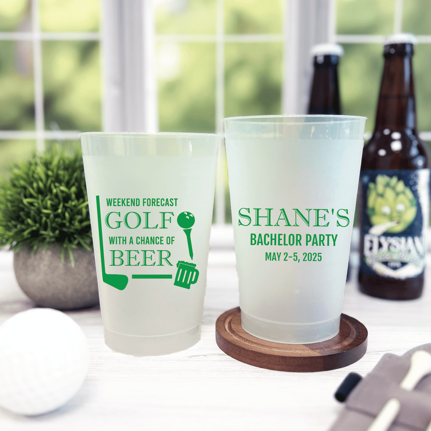 Frosted plastic cups with green golf and bachelor party designs, one reading "Weekend Forecast Golf with a Chance of Beer" and the other "Shane's Bachelor Party May 2-5 2025"