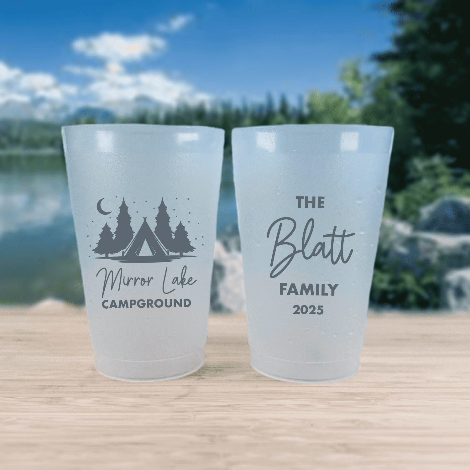 Two frosted cups with camping designs: left cup features tent and tree silhouette with "Mirror Lake Campground" text, right cup reads "The Blatt Family 2025"