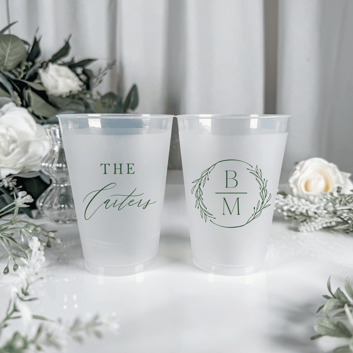 Sage green ink frosted shatterproof wedding cups with The Carters script surname and B M wreath monogram