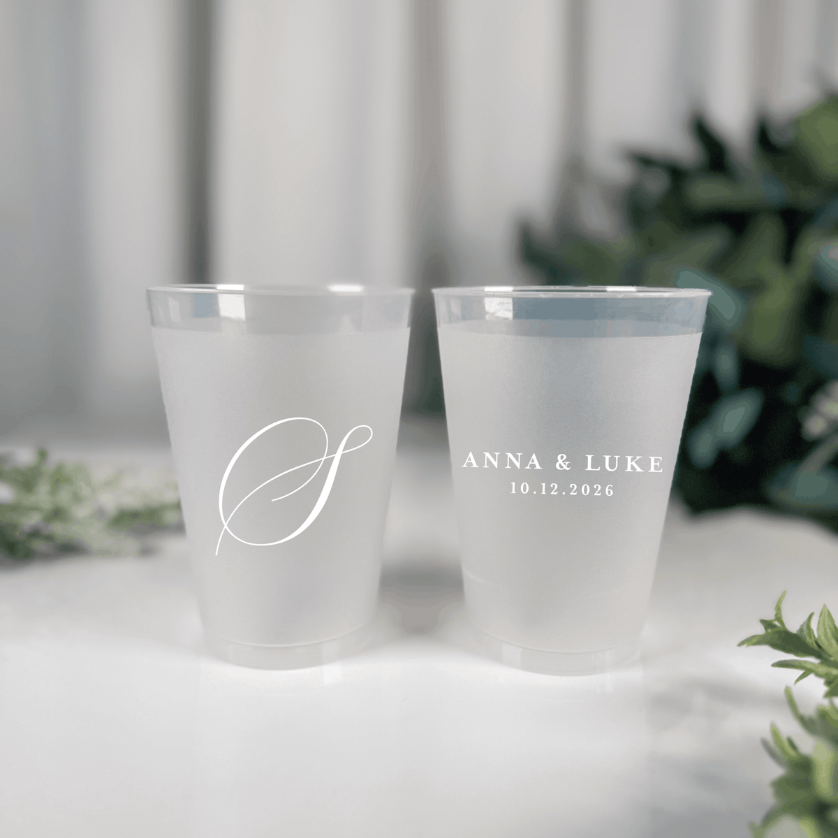 White ink frosted shatterproof wedding cups with large script S initial and Anna & Luke wedding date