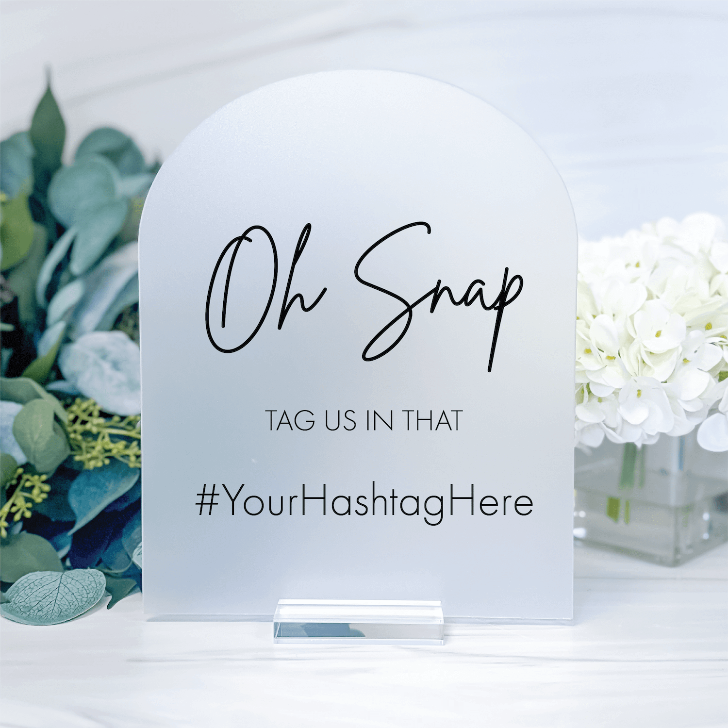 White acrylic arch sign with "Oh Snap" script text, "TAG US IN THAT" and customizable hashtag placeholder for wedding reception displays.