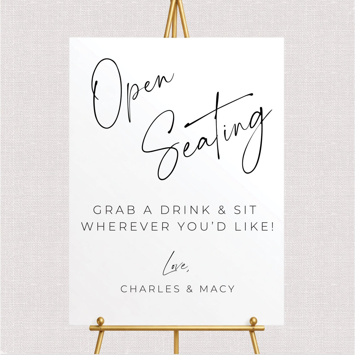 Personalized rectangular open seating wedding sign featuring black lettering, grab a drink and sit wherever you'd like wording, and couple's names.