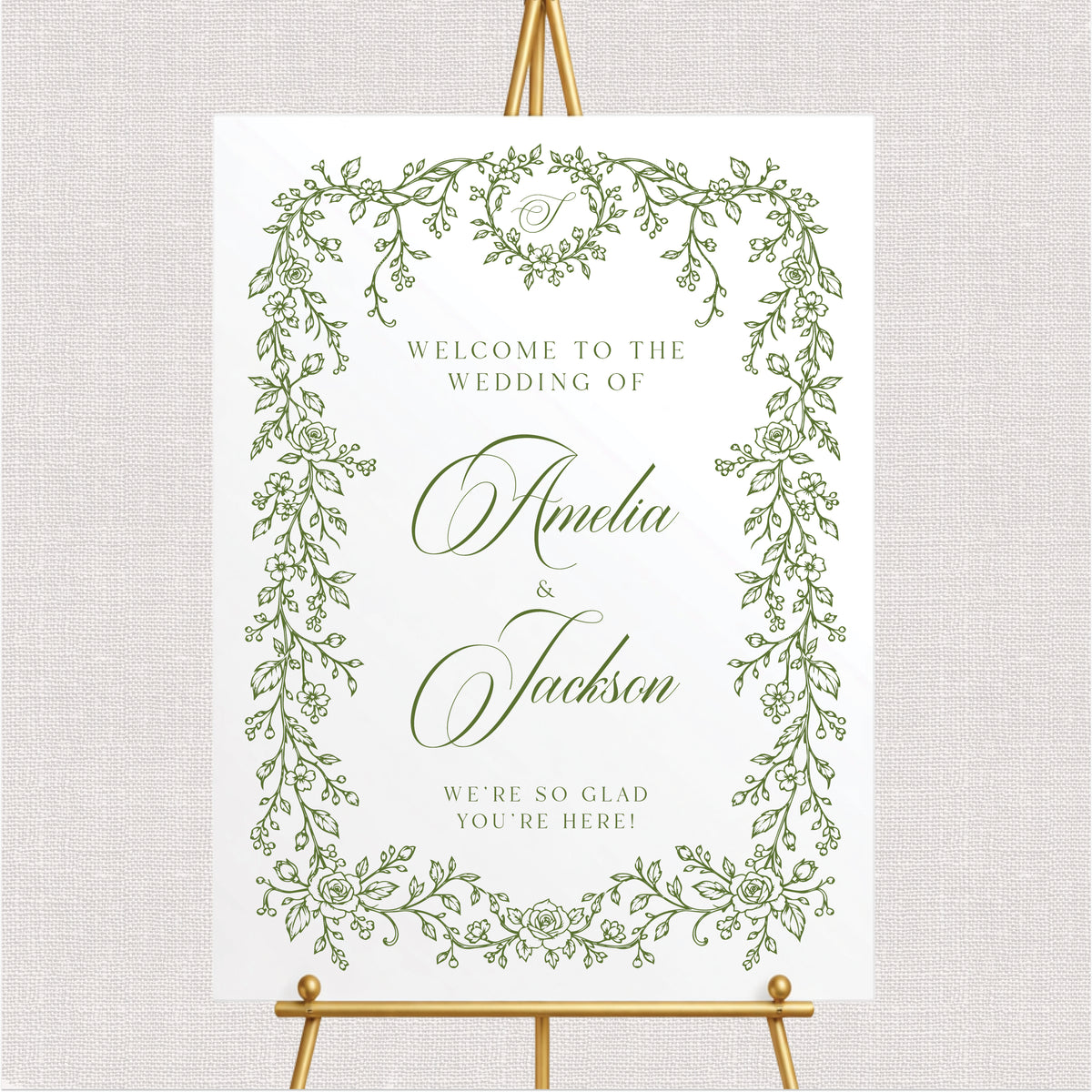 Personalized vintage floral wedding welcome sign with delicate botanical border and elegant brown calligraphy displayed at an outdoor garden wedding.
