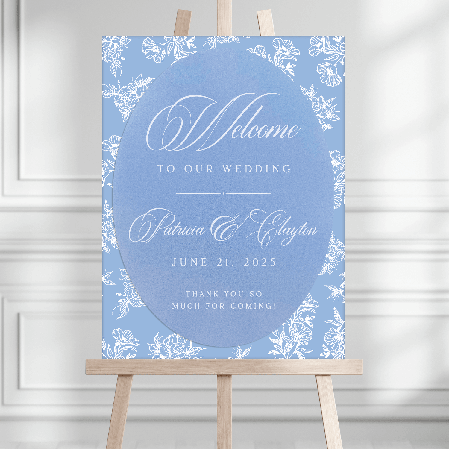 Blue toile floral wedding welcome sign with couple names Patricia and Clayton and date June 21, 2025 displayed on wooden easel.