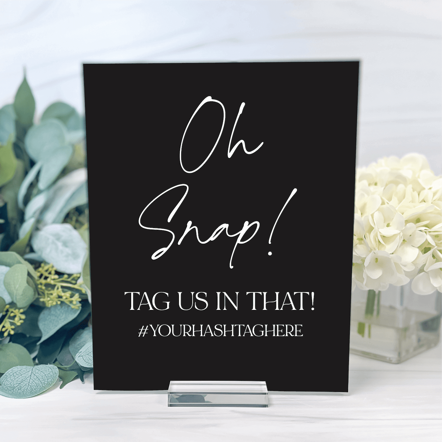 Black acrylic sign with white handwritten "Oh Snap!" text and hashtag placeholder for wedding photo display