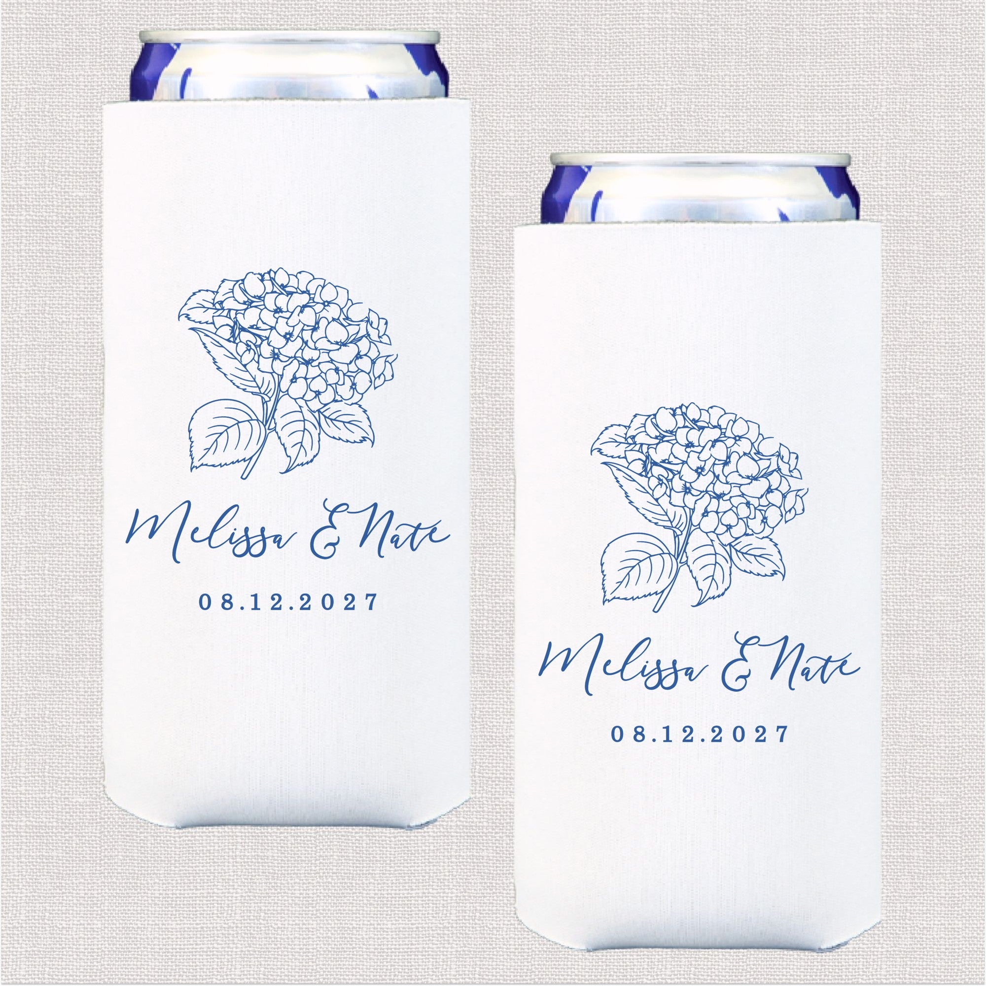A pair of white slim fabric can coolers, each featuring a blue outline illustration of a hydrangea floral bouquet, designed to keep drinks cool for a wedding.