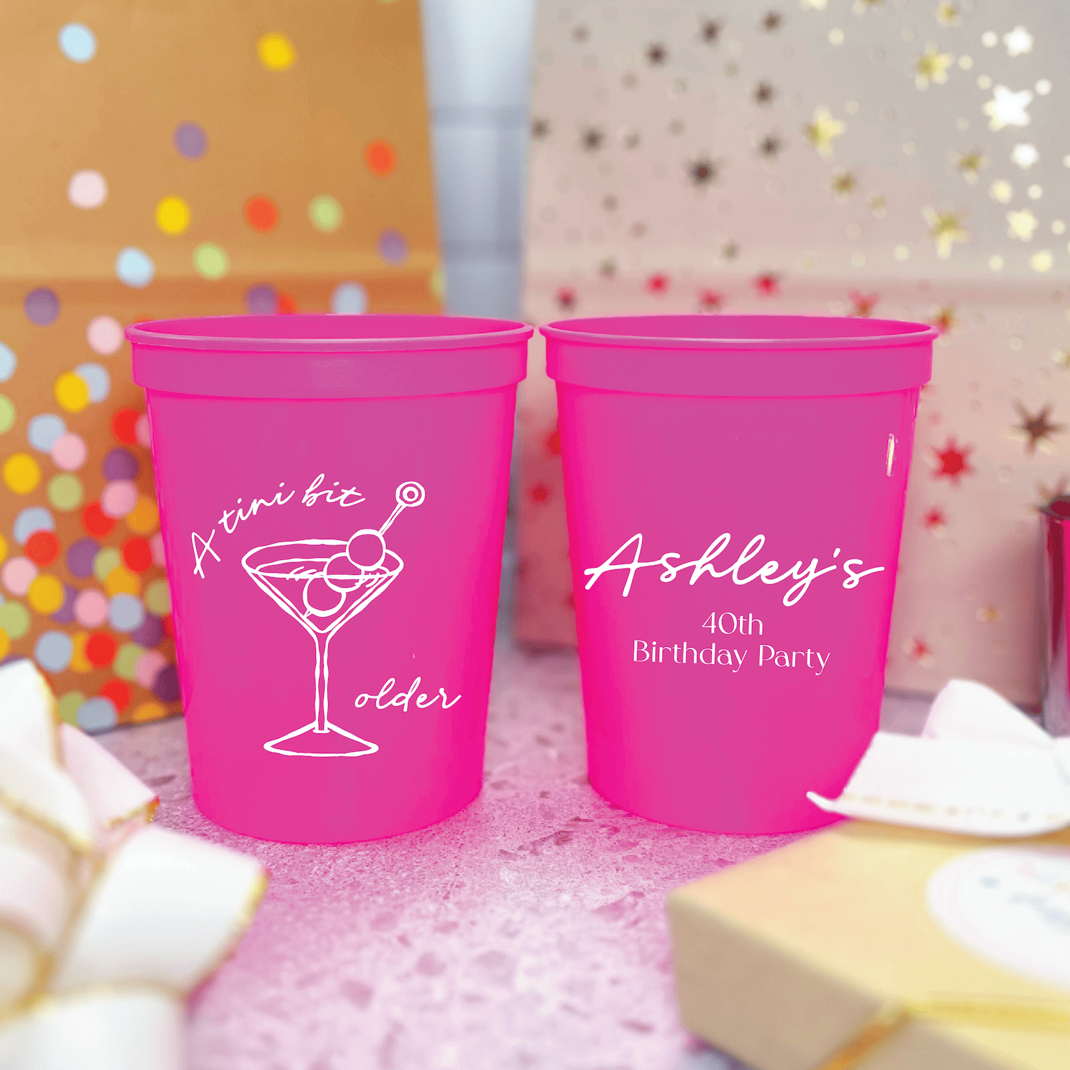 Bright pink stadium cups with white martini glass design and personalized text for a 40th birthday party celebration
