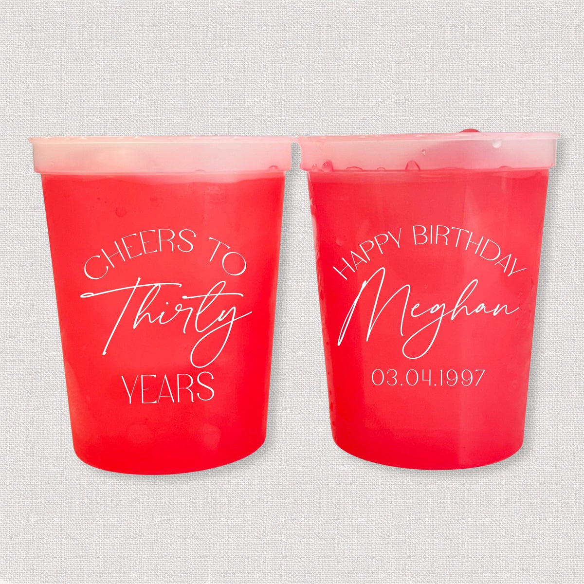 Red color changing birthday stadium cups with Cheers to Thirty Years arch and Happy Birthday Meghan personalization