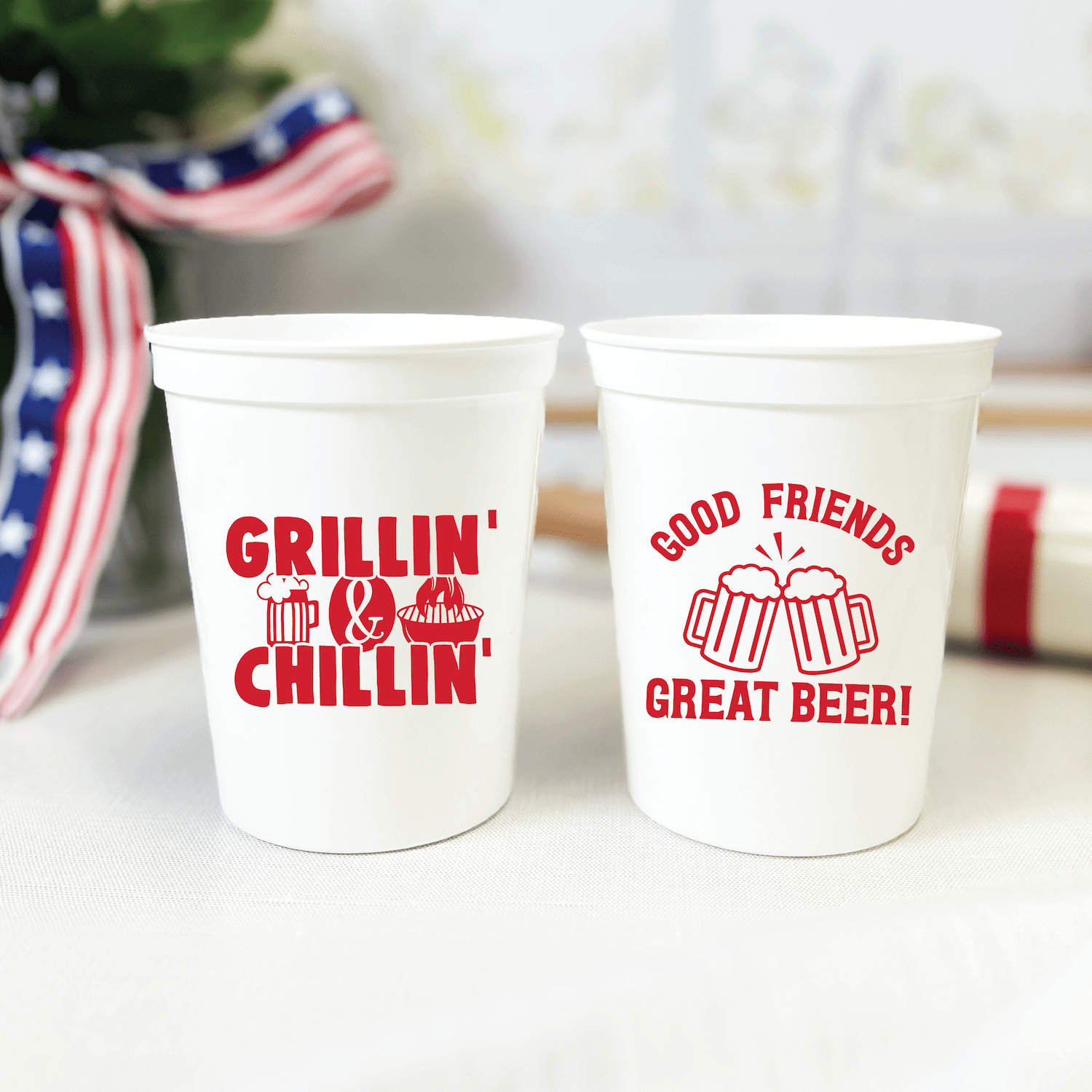 Two white stadium cups with red text, one reading "Grillin' & Chillin'" and the other "Good Friends Great Beer" with beer mug graphics.