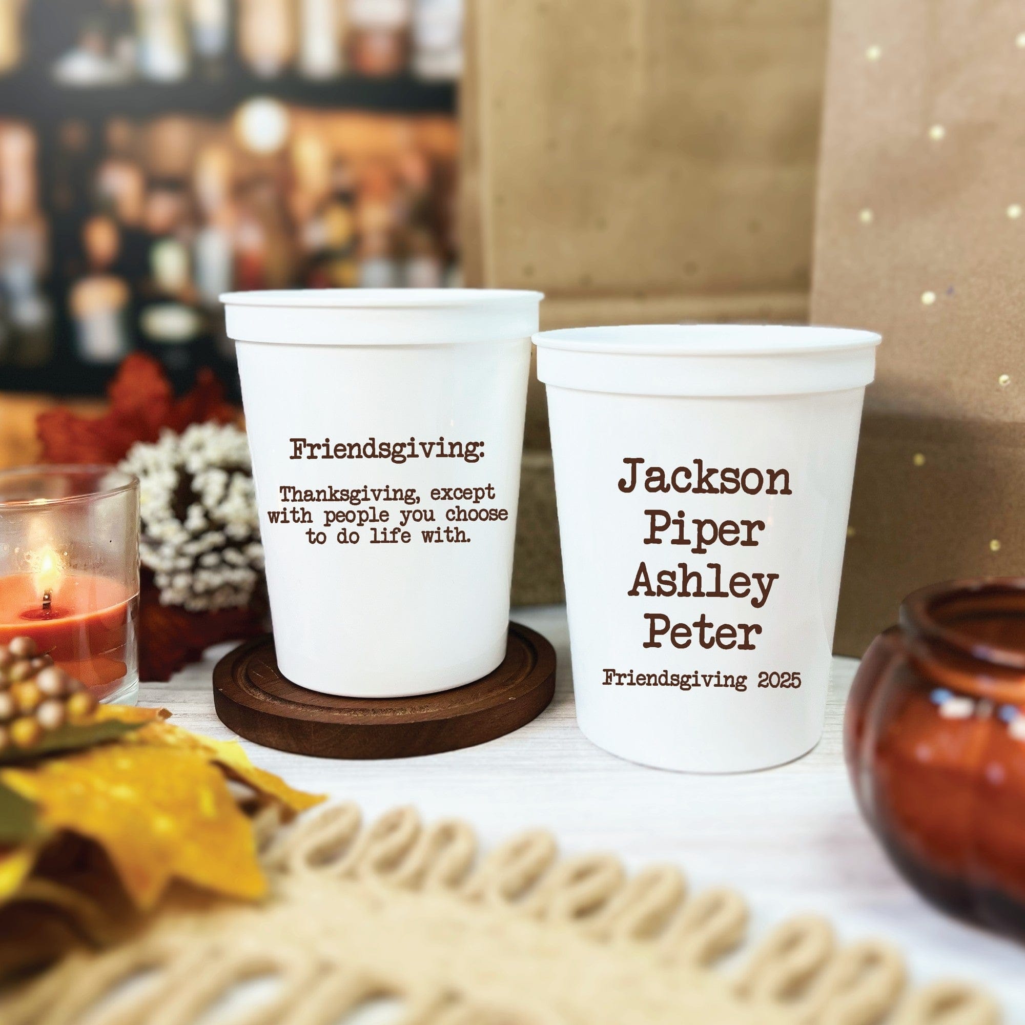 Two white reusable plastic cups are customized with unique designs, ideal for a Friendsgiving or fall-themed gathering.
