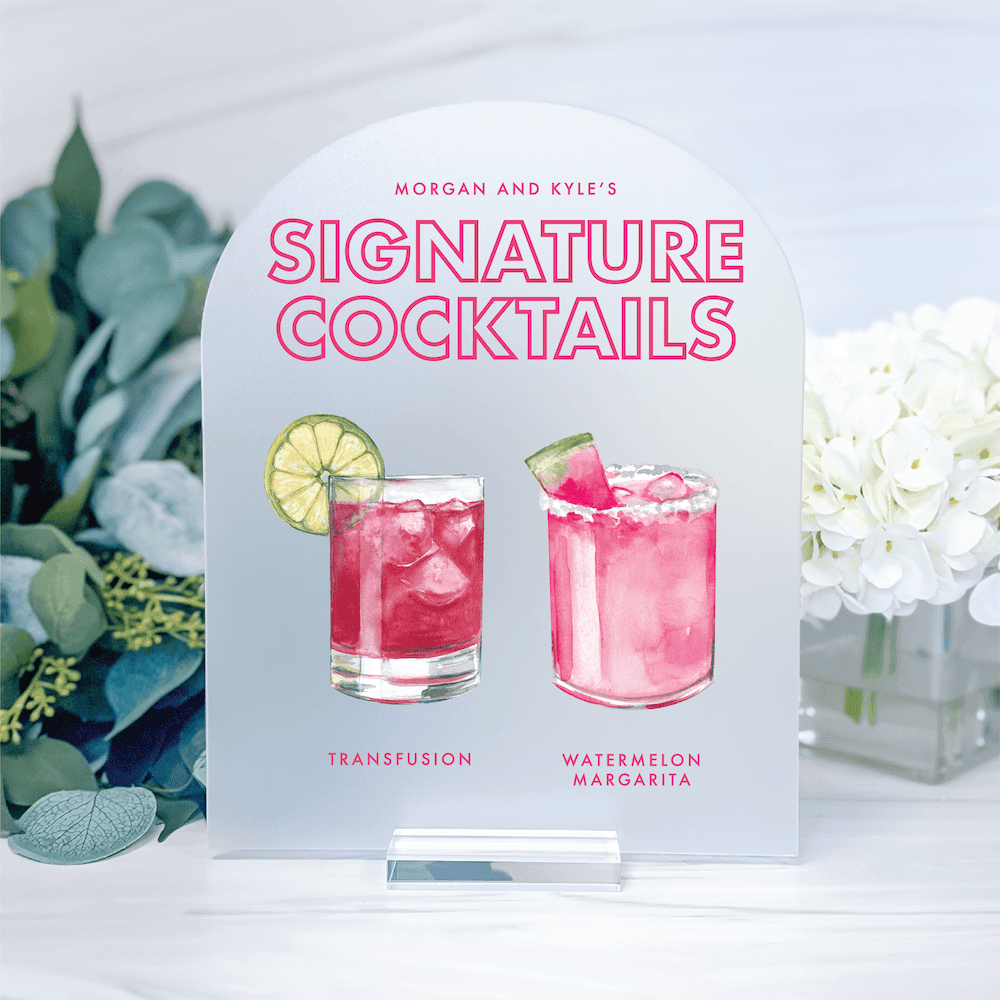 Personalized acrylic bar sign displaying "Morgan and Ayle's Signature Cocktails" with illustrated pink cocktail drinks and recipe names.