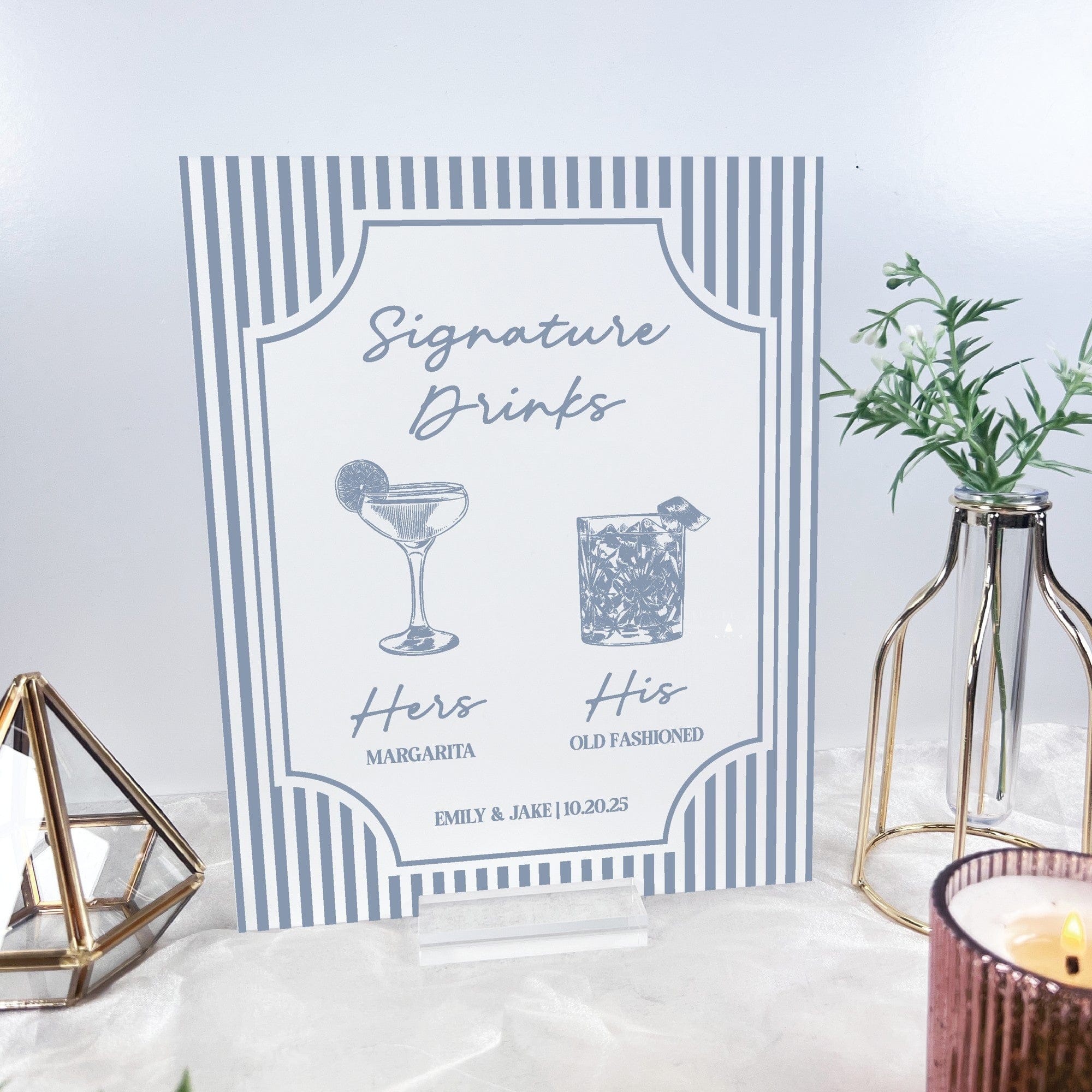 A personalized rigid sign featuring light blue vertical stripes on a white background, displaying 'Signature Drinks' with illustrations of two different cocktails, designed for a wedding or special event bar area.