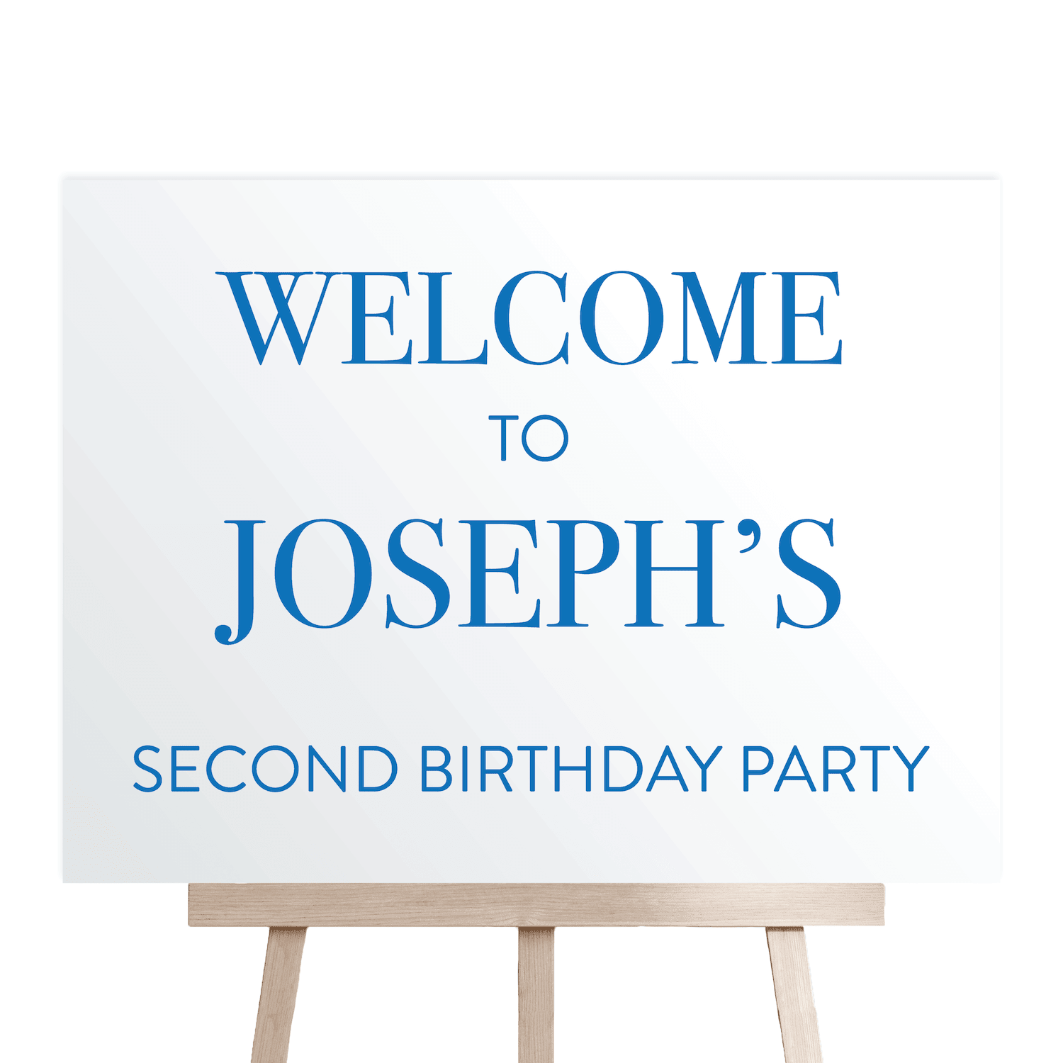 White welcome sign with blue text reading "Welcome to Joseph's Second Birthday Party" on wooden easel stand.