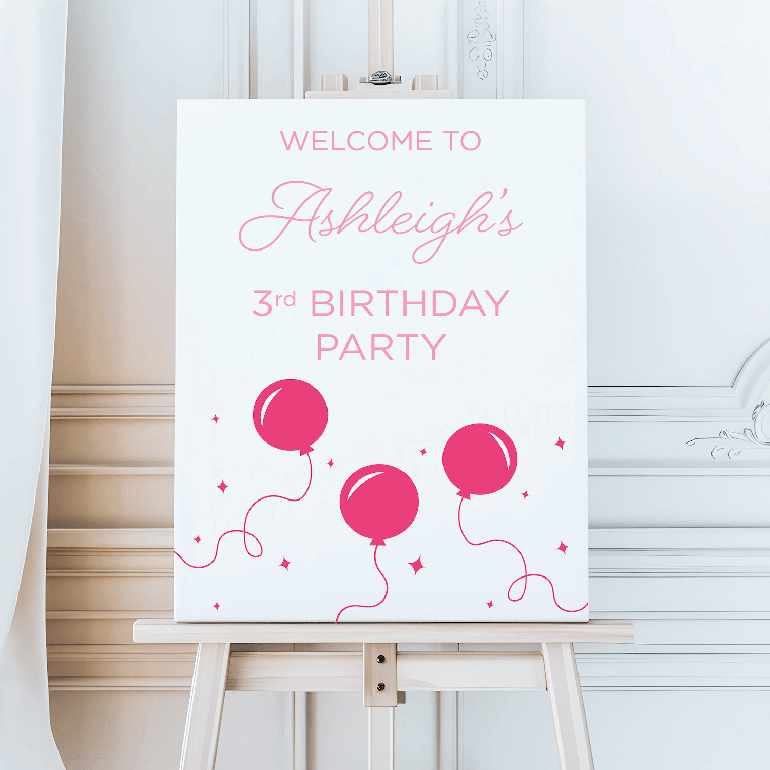 White welcome sign with pink text reading "Welcome to Ashleigh's 3rd Birthday Party" and illustrated pink balloons with confetti details.