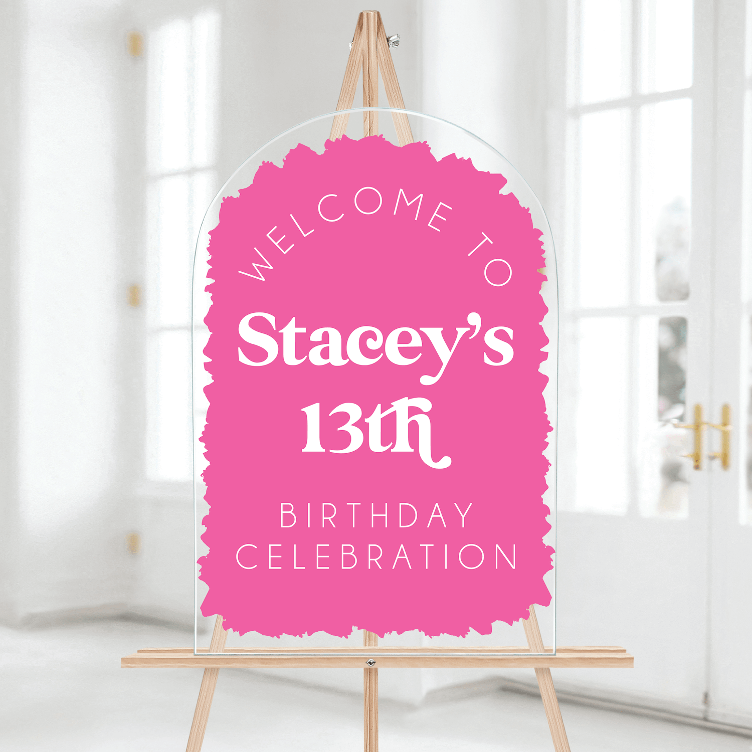 Pink scalloped welcome sign reading "Welcome to Stacey's 13th Birthday Celebration" on wooden easel