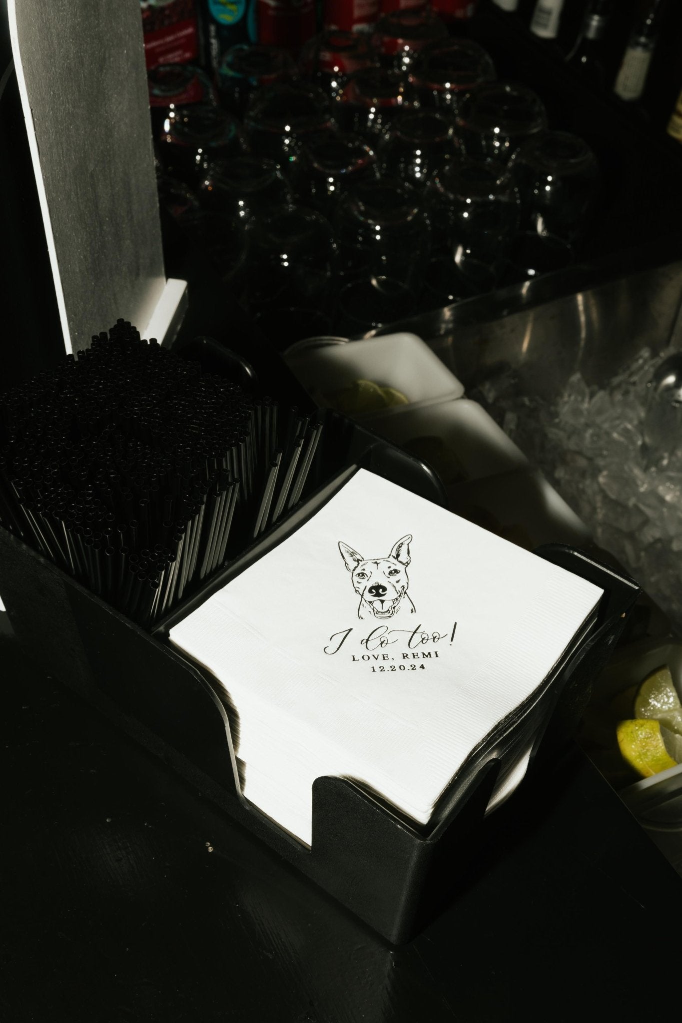 Elegant white paper cocktail napkins featuring a custom pet illustration, perfectly arranged for a celebratory bar service.