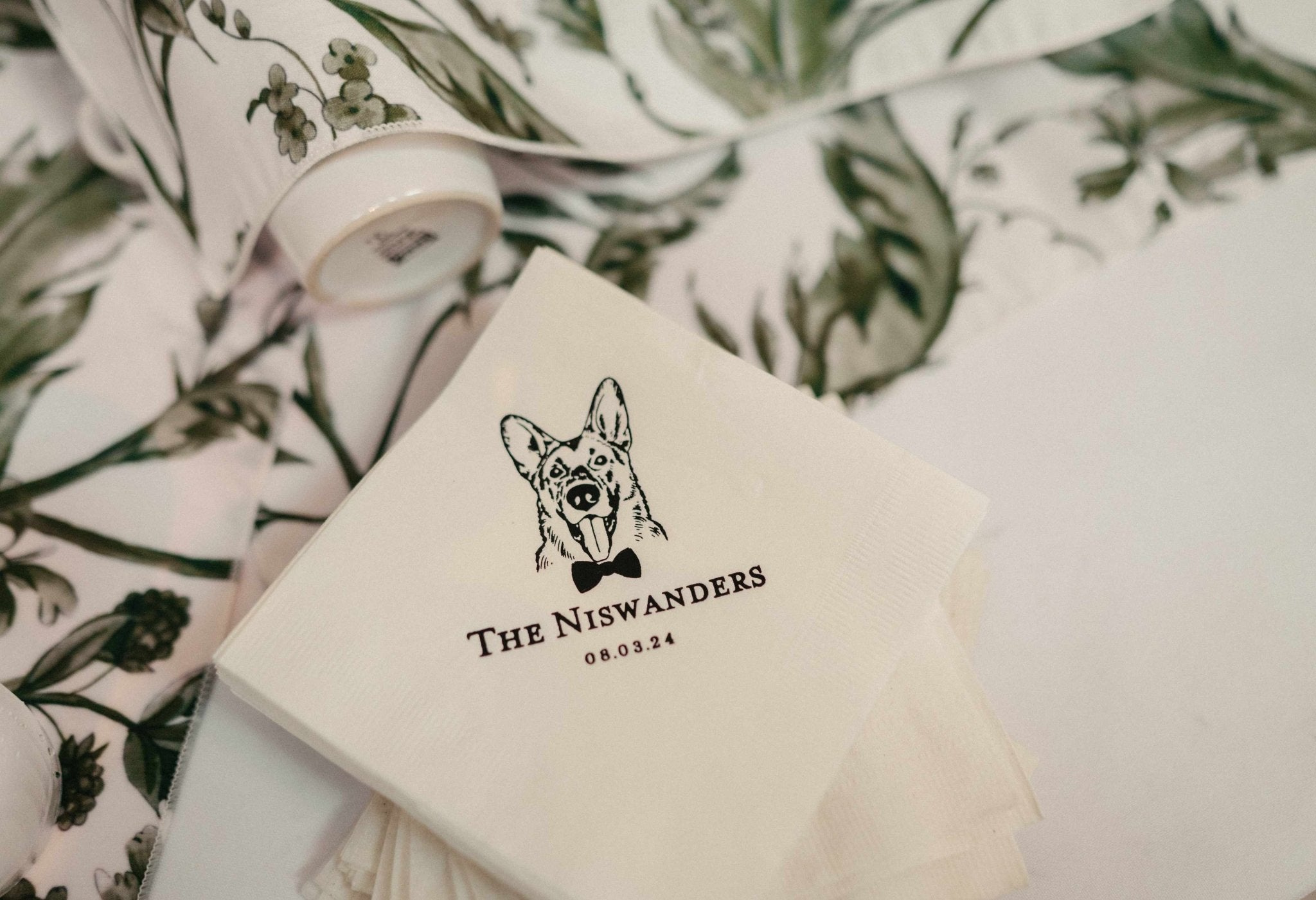 Elegant cream paper napkins with a charming custom animal illustration in dark ink, perfect for adding a personalized touch to special event celebrations.