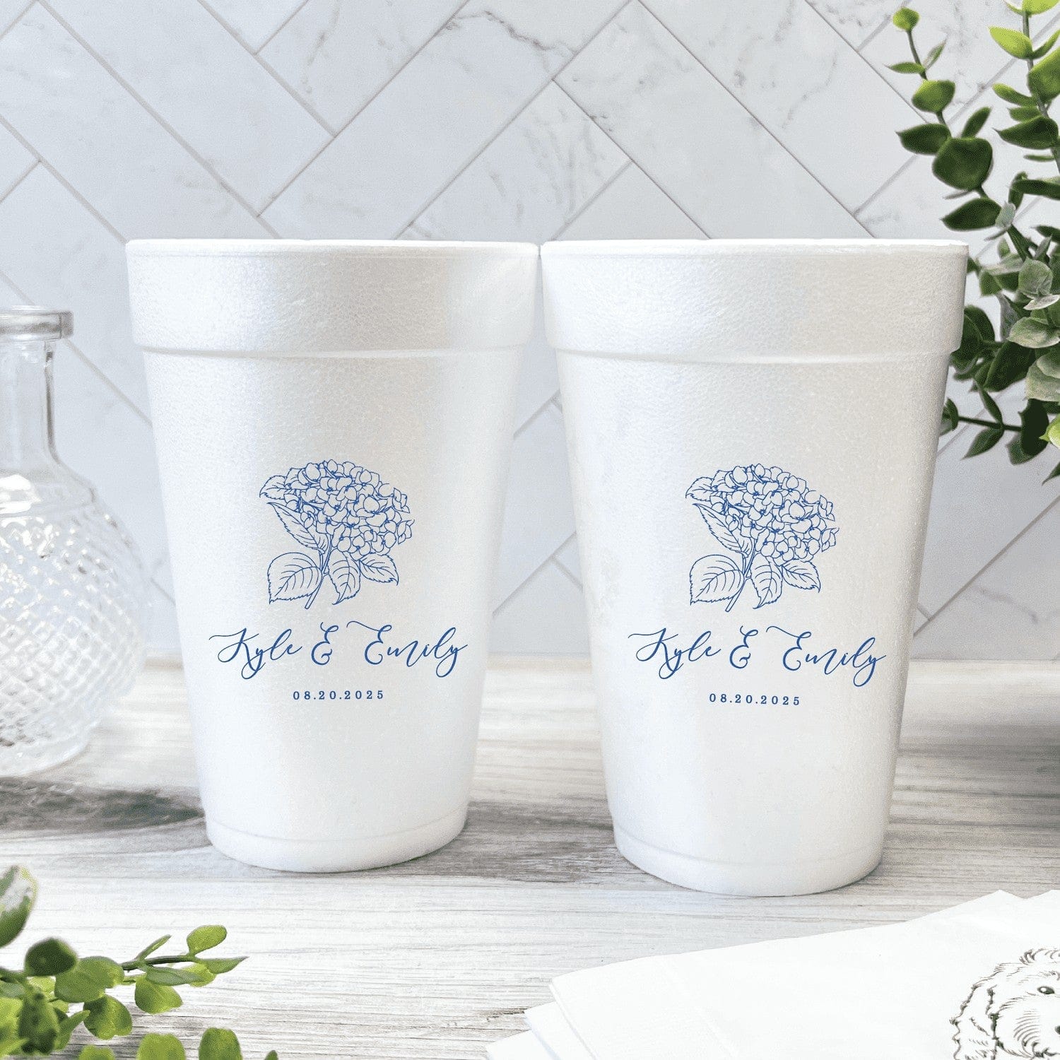 Personalized foam cups featuring a blue hydrangea illustration and custom text, ideal for a wedding celebration.